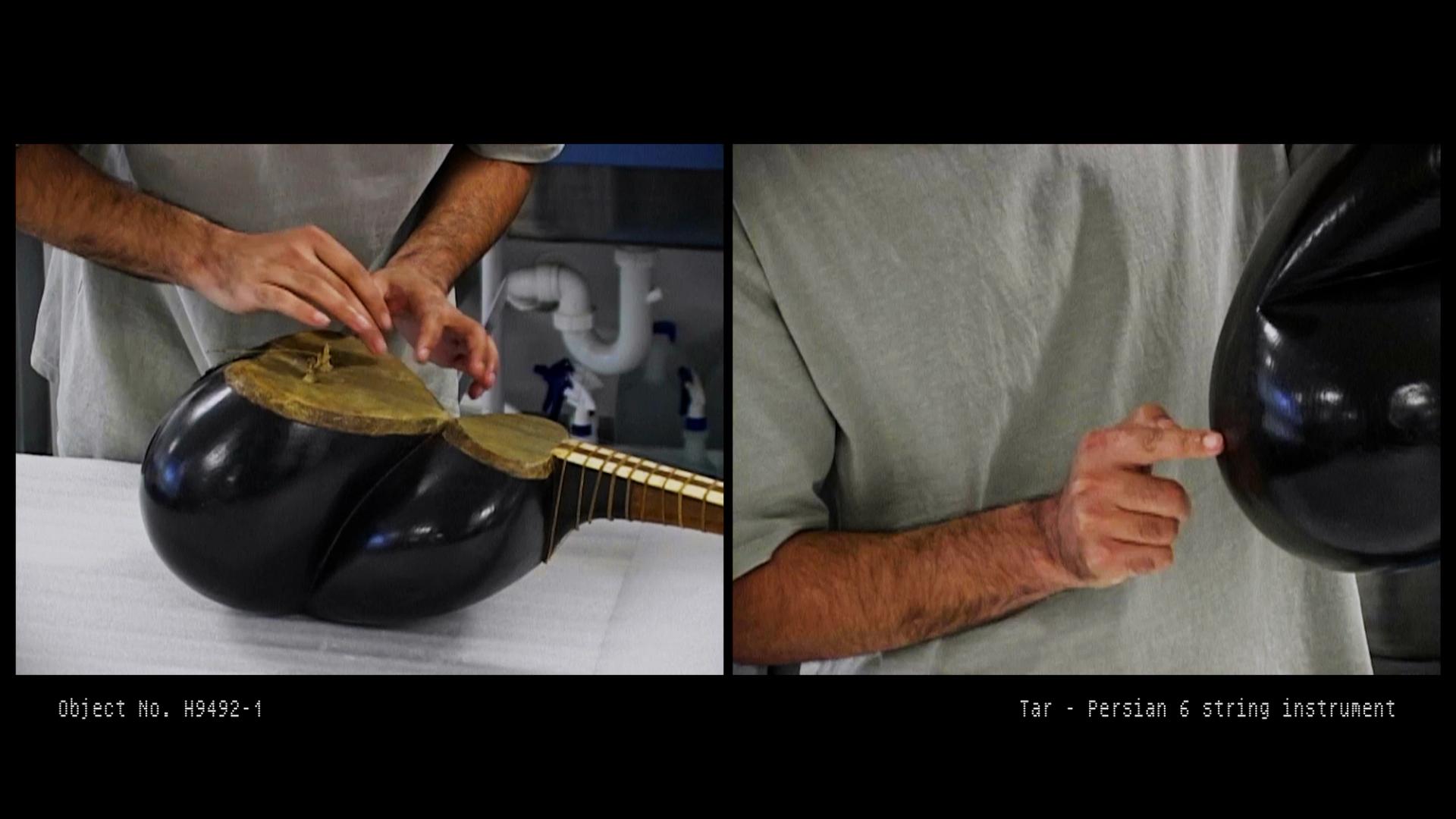 Hamed Sadeghi inspects the Persian tar musical instrument