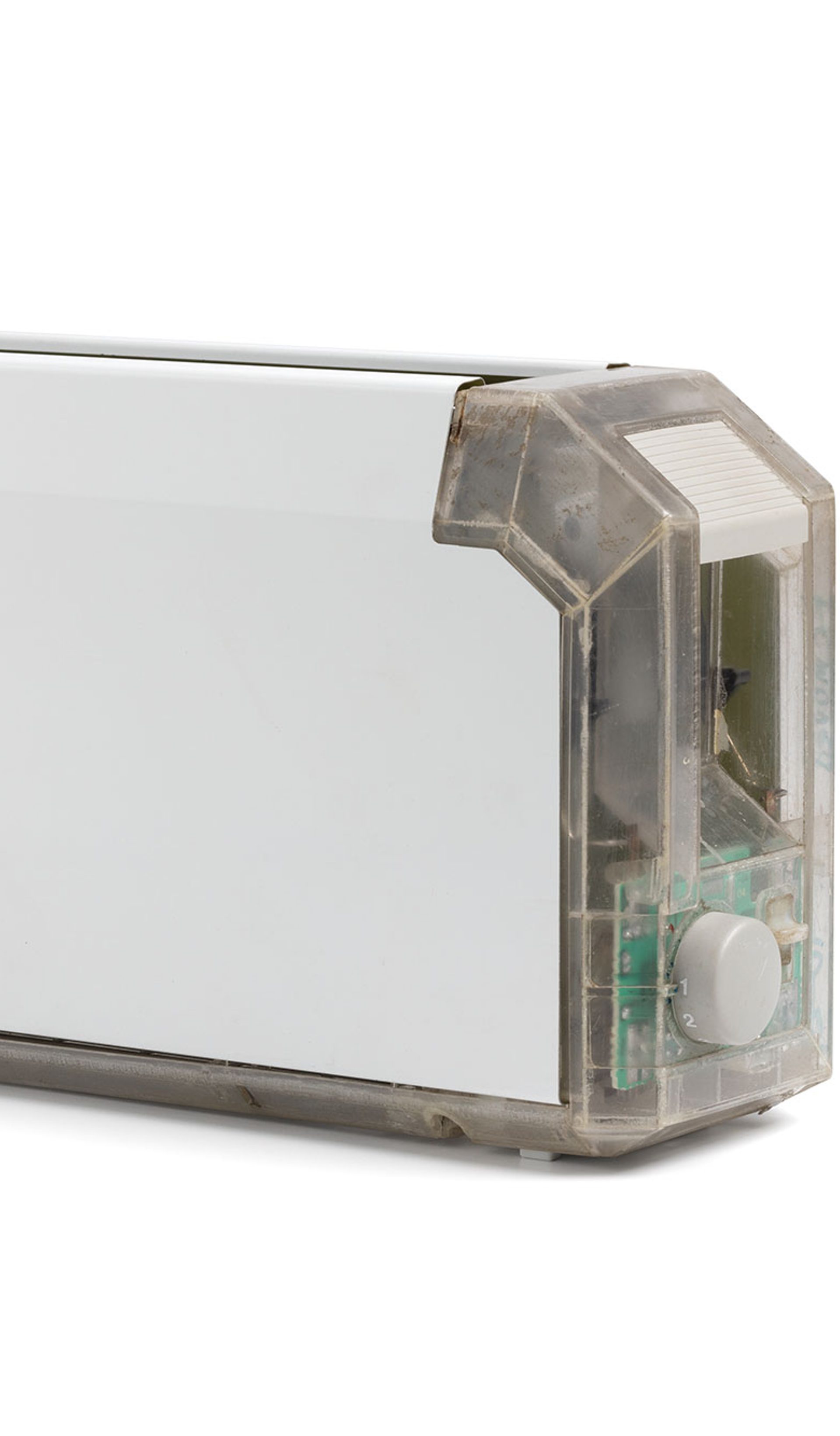A long and thin white toaster with a clear end showing the internal mechanisms.
