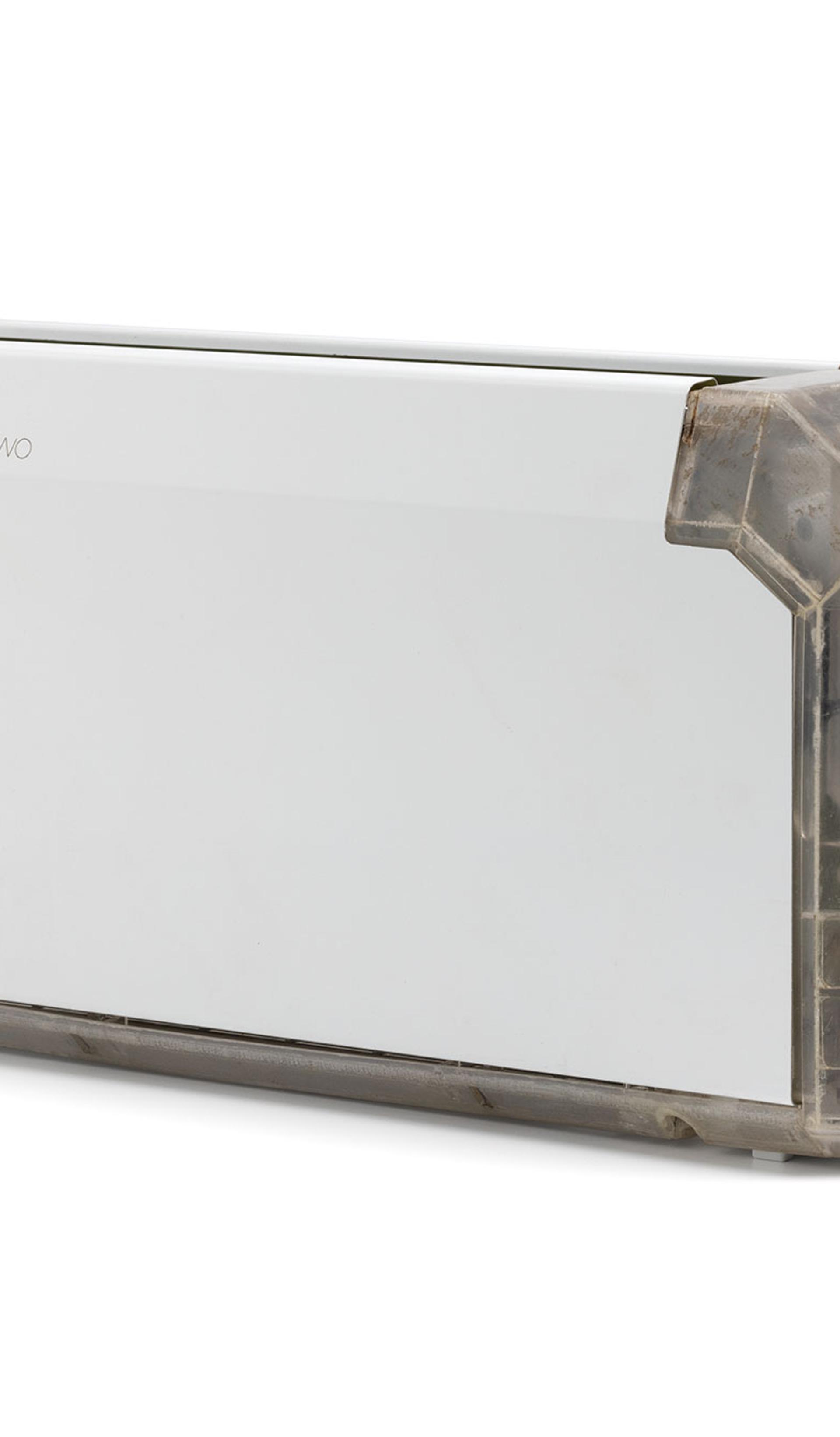 A long and thin white toaster with a clear end showing the internal mechanisms.
