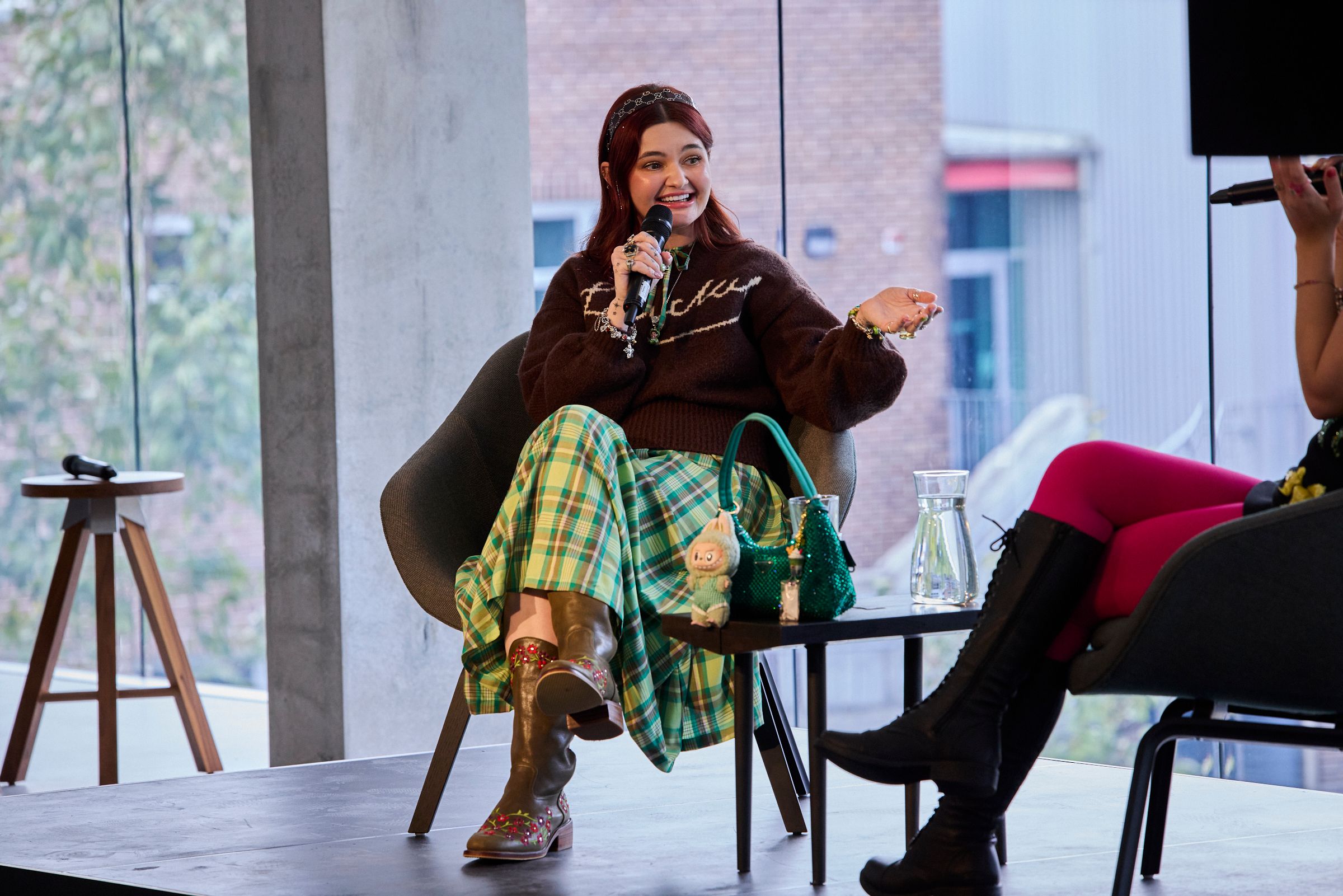 Guest Sam Todd seated on a stage during a talk.