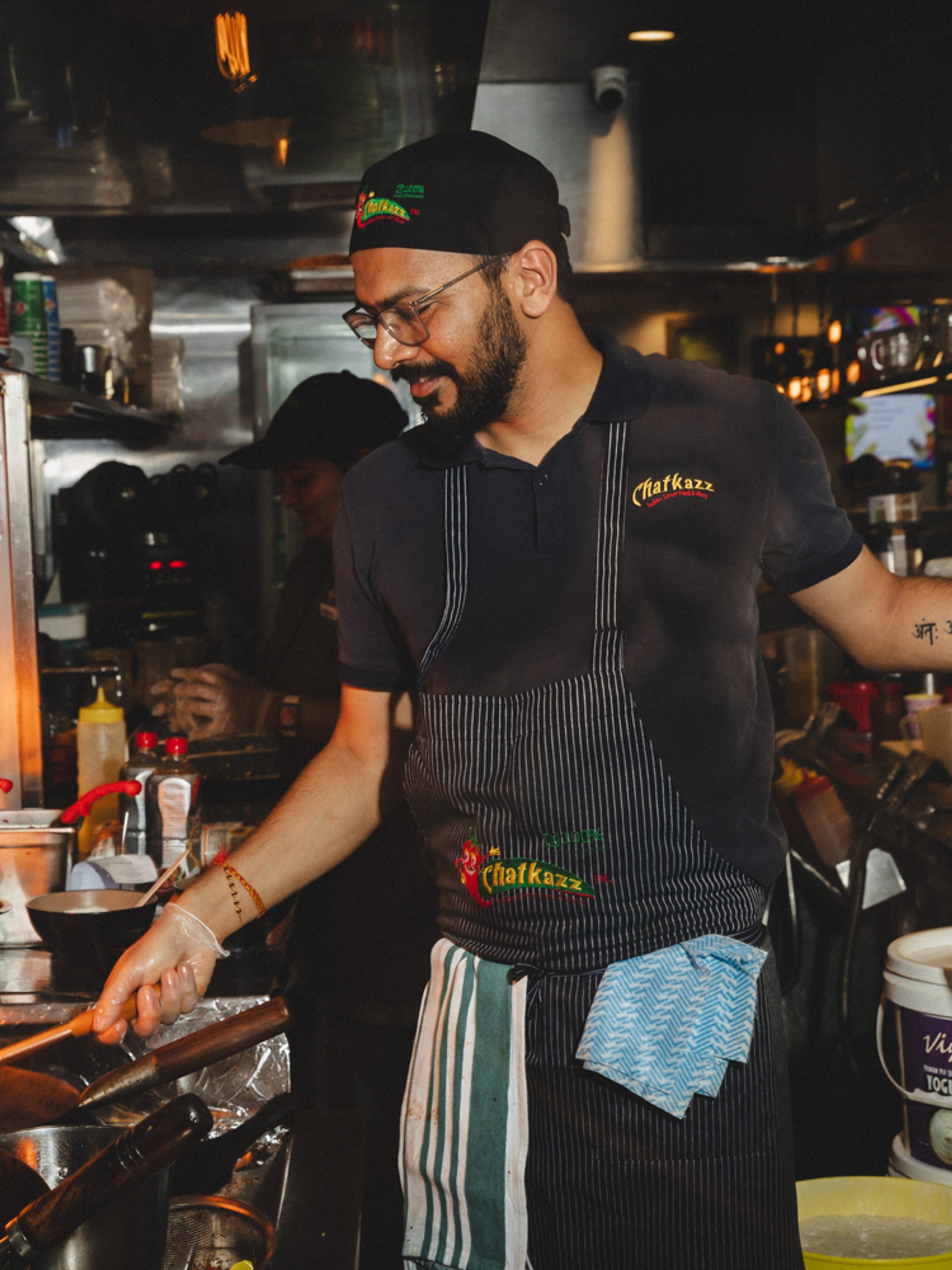 Chef cooking with fire in a kitchen.