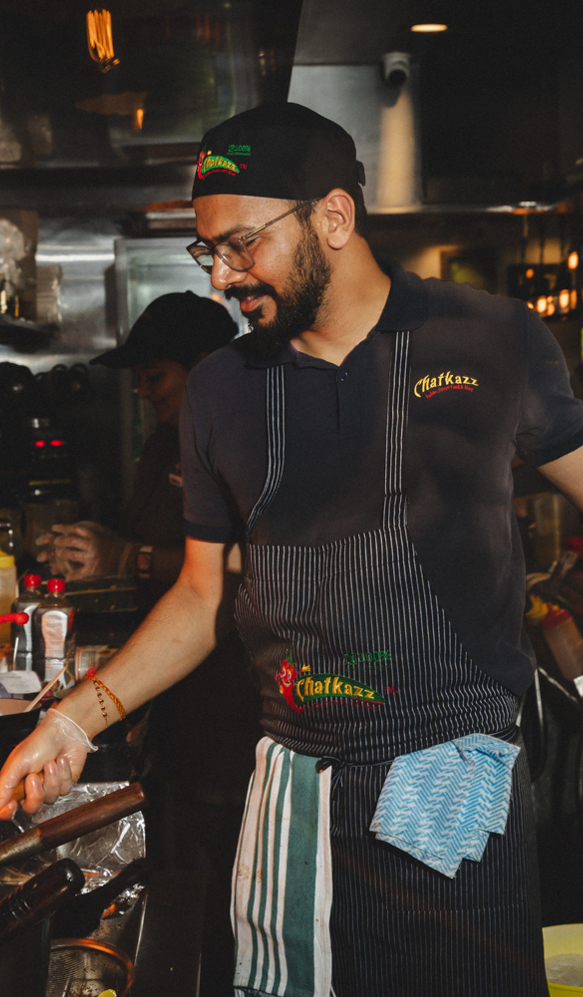 Chef cooking with fire in a kitchen.