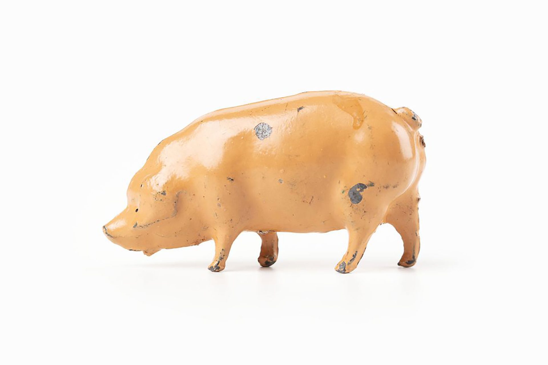 Small toy pig, light pink in colour.