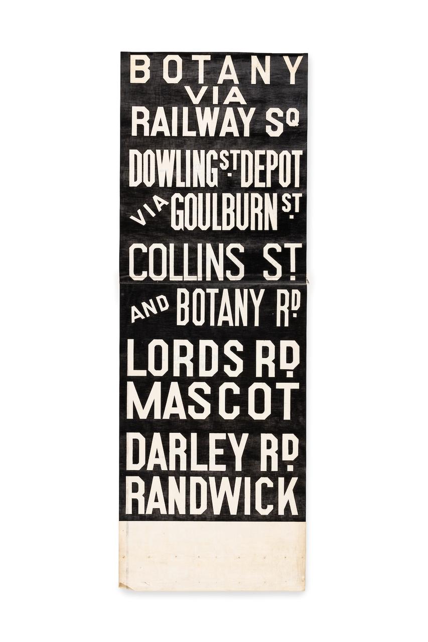 Black sign with white lettering stating destination names.