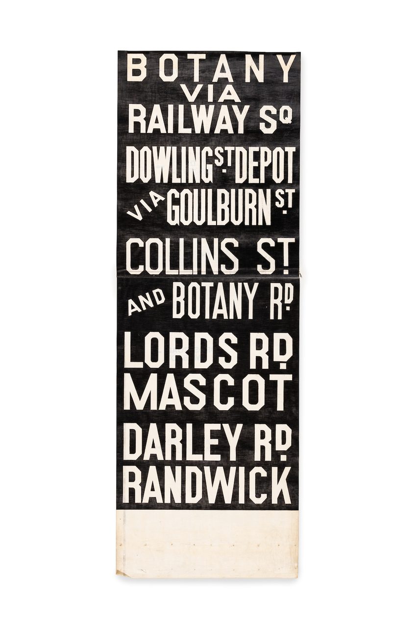 Black sign with white lettering stating destination names.