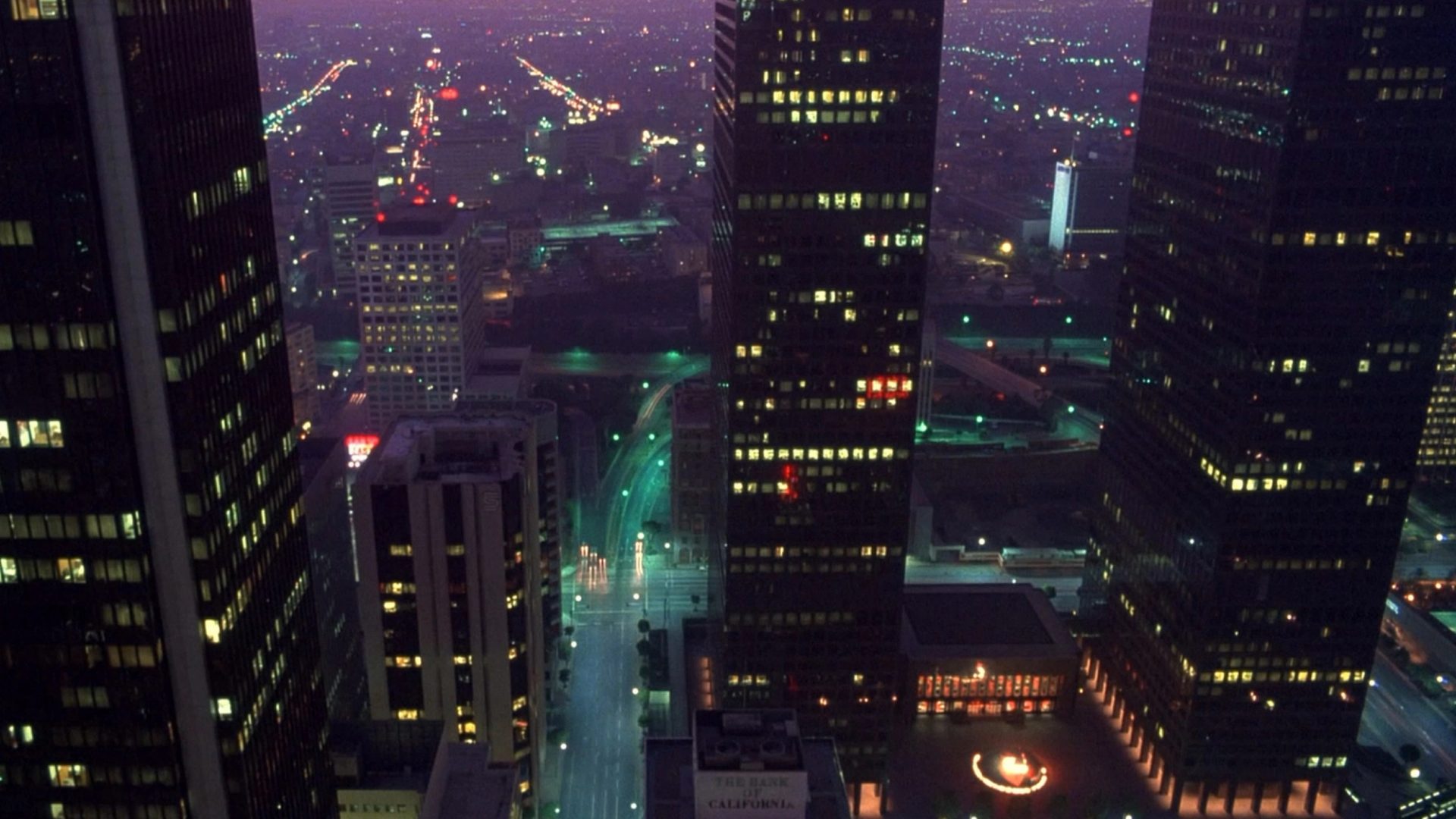 Cityscape at night with tall building in forefront