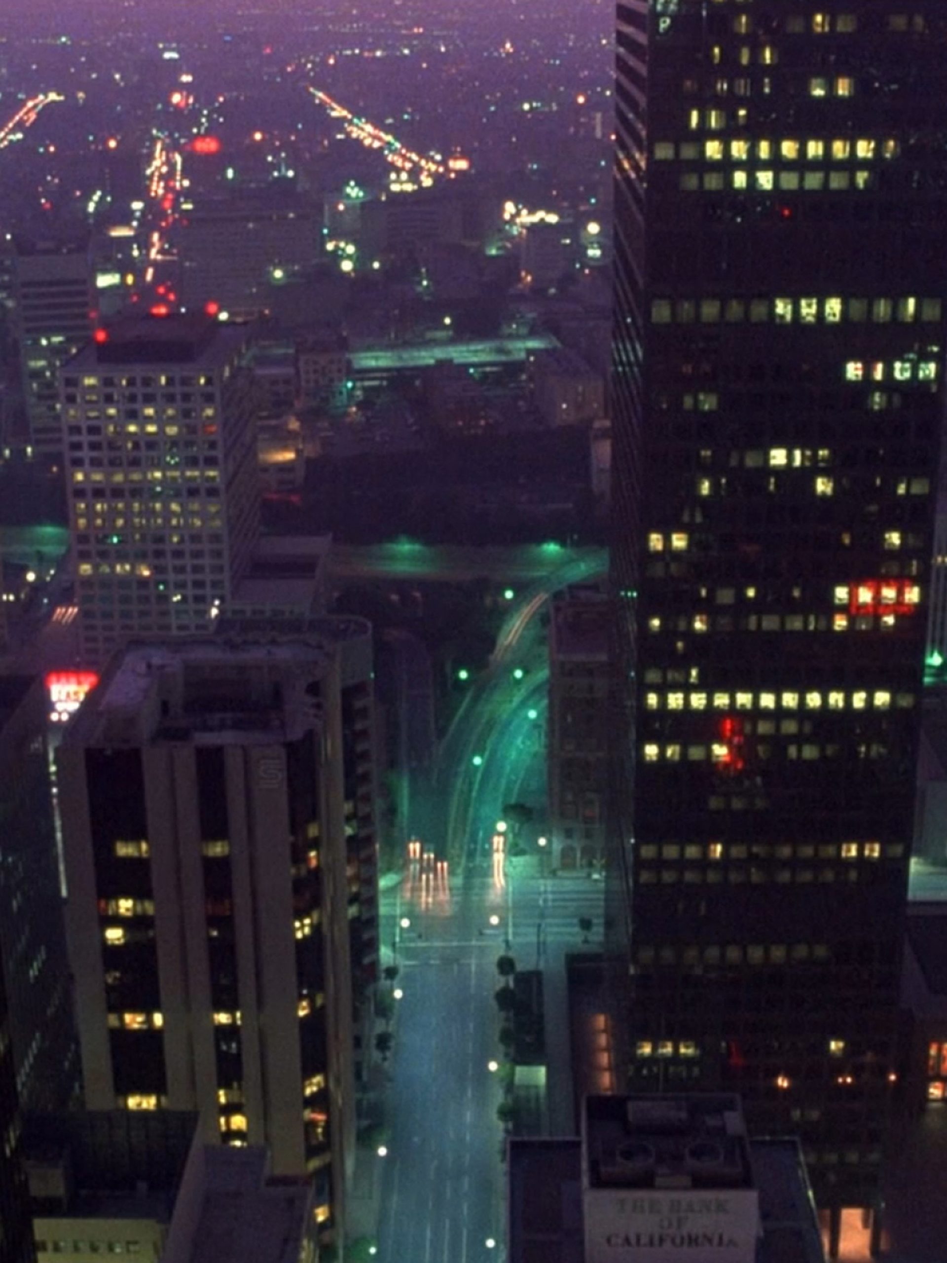 Cityscape at night with tall building in forefront