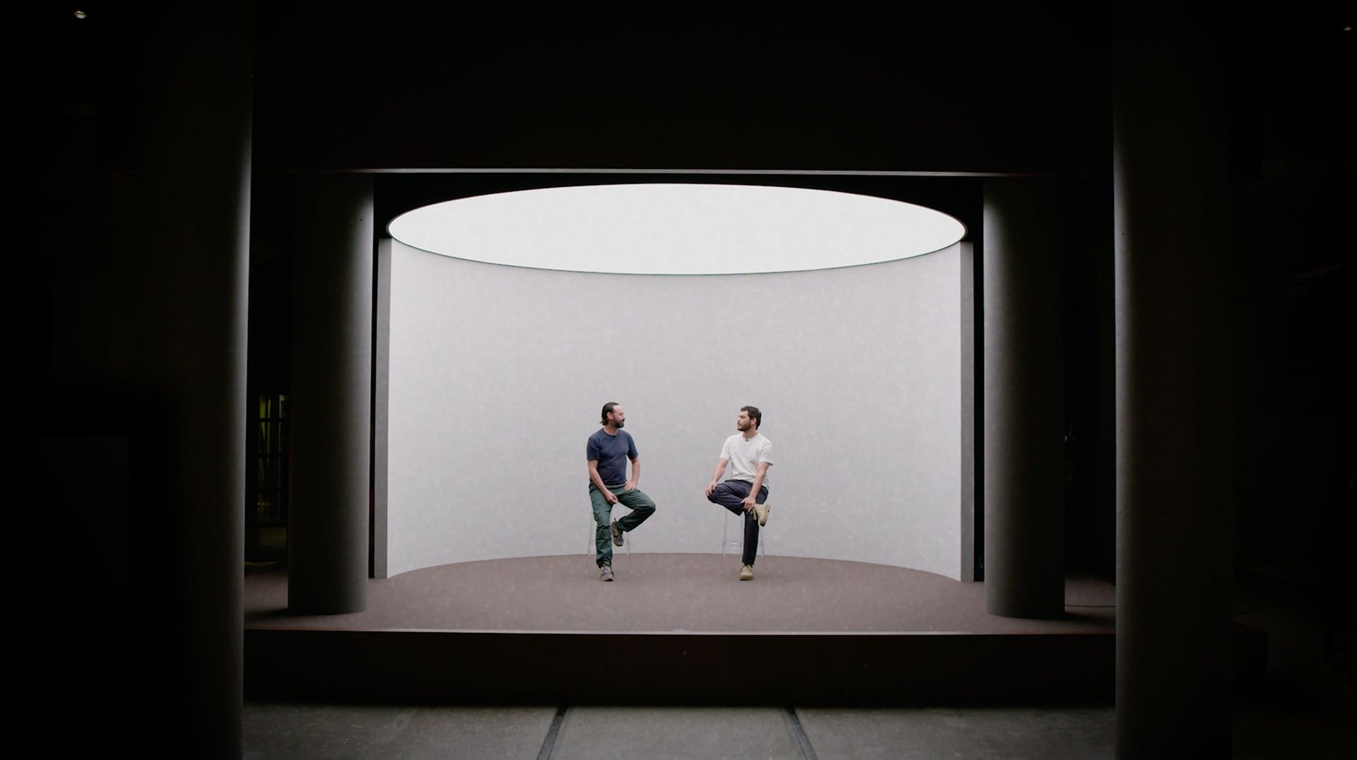 Rhys Ripper and Nathan McGuire sit on a stage in the Powerhouse talking to one another.