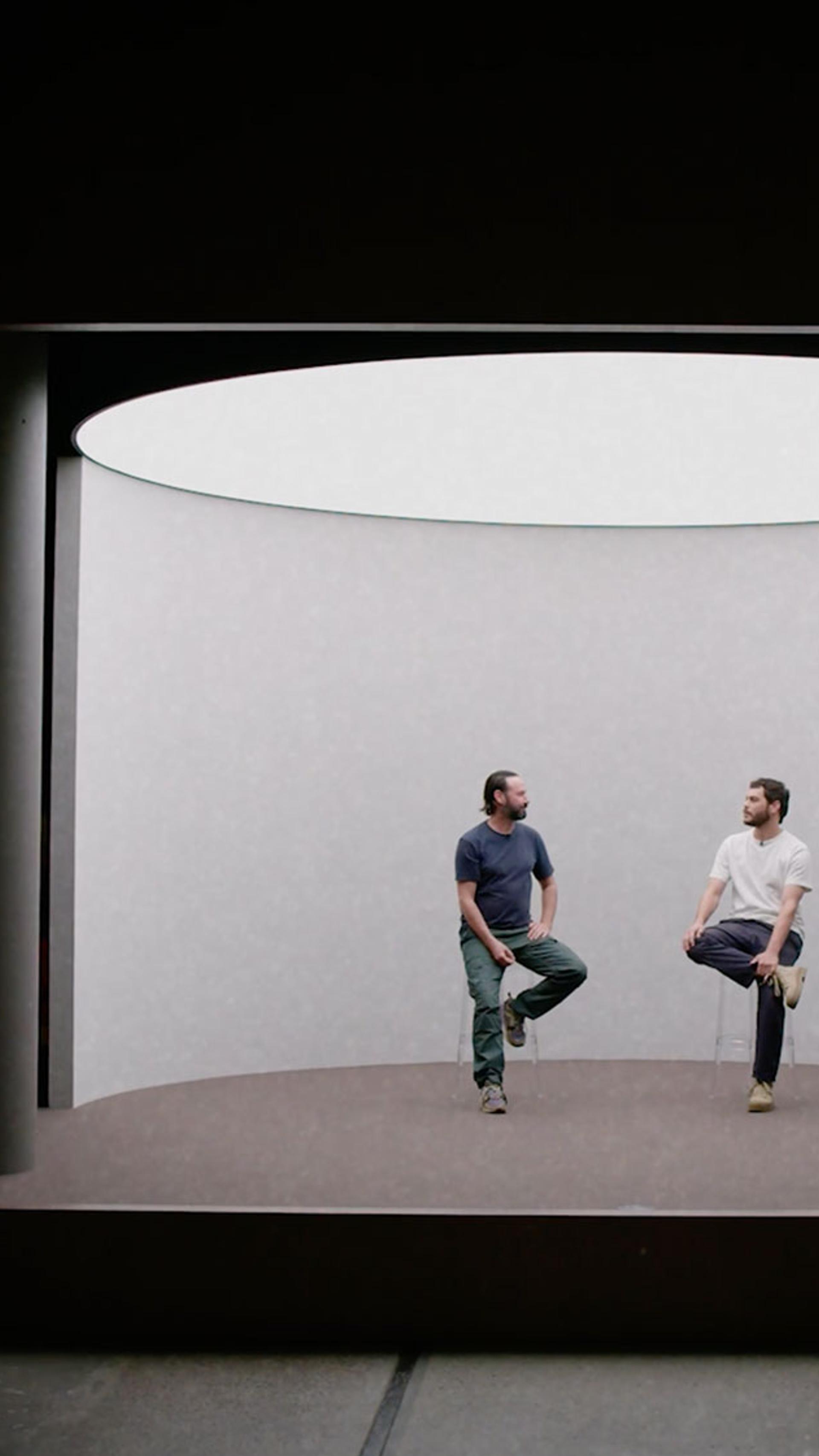 Rhys Ripper and Nathan McGuire sit on a stage in the Powerhouse talking to one another.