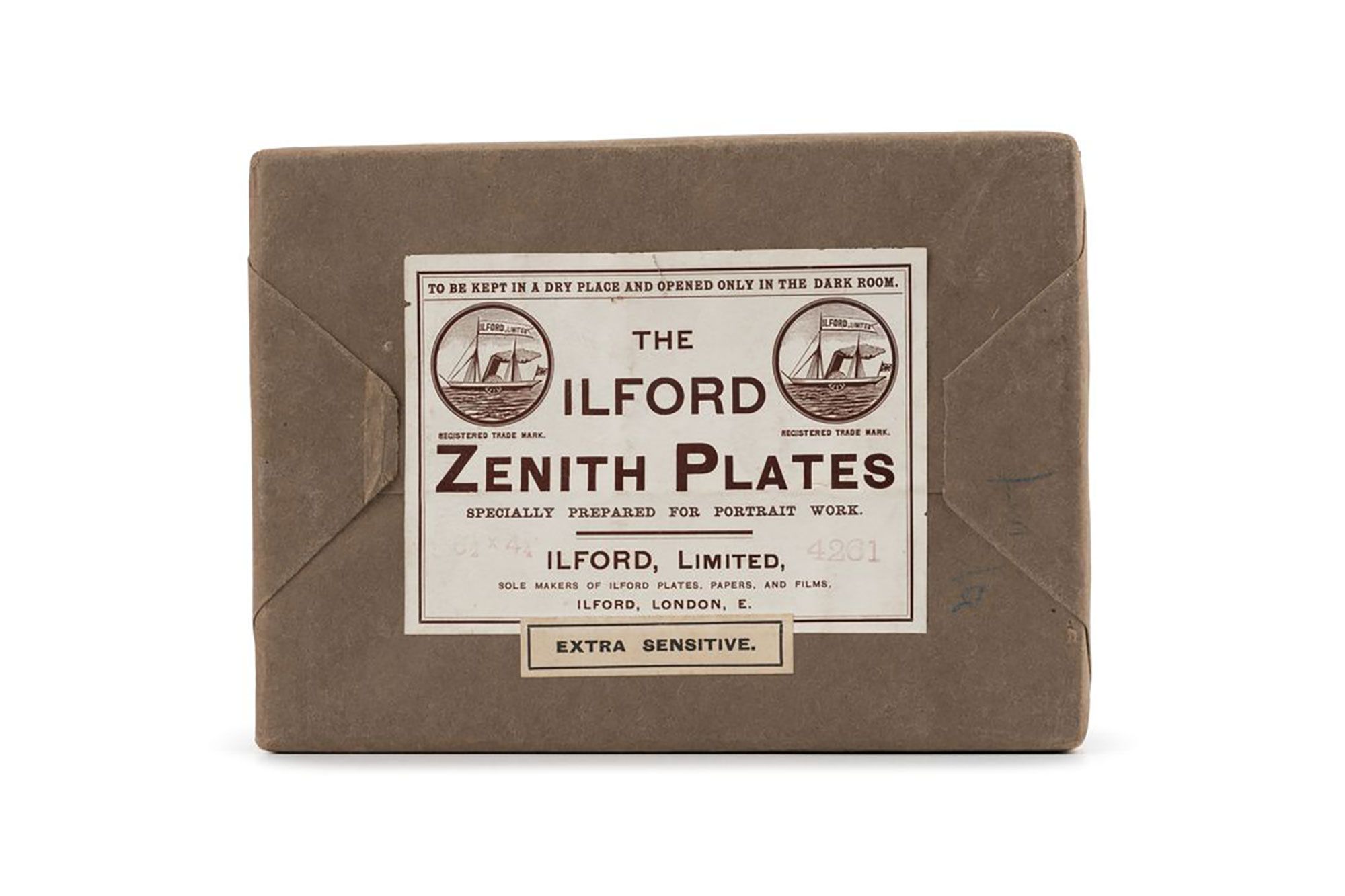 Flat rectangular box sealed in brown paper. White paper label on front reads "THE / ILFORD / ZENITH PLATES / SPECIALLY PREPARED FOR PORTRAIT WORKS / 6 1/2 X 4 3/4 " 4261 / ILFORD, LIMITED / SOLE MAKERS OF ILFORD PLATES, PAPERS / AND FILMS. / ILFORD, LONDON, /EXTRA SENSITIVE"