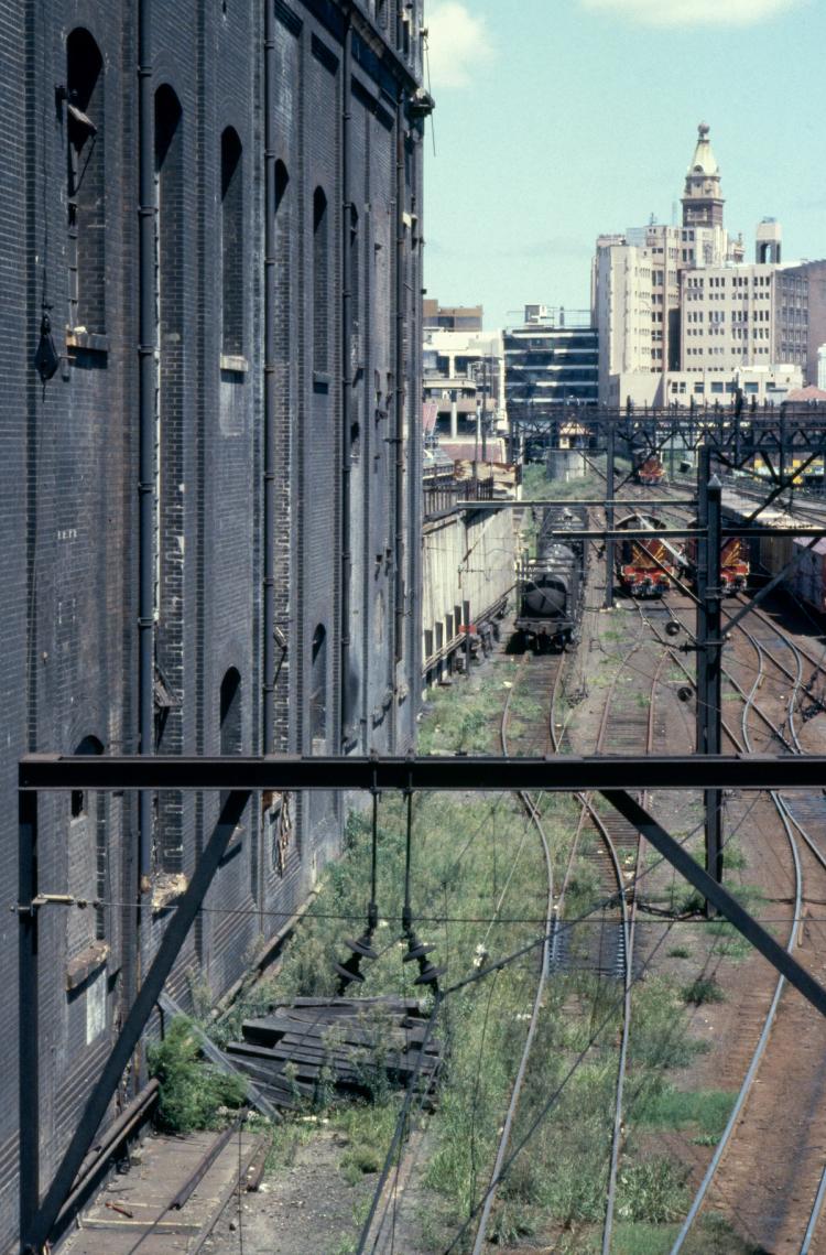 Colour image of a building facade and train moving
