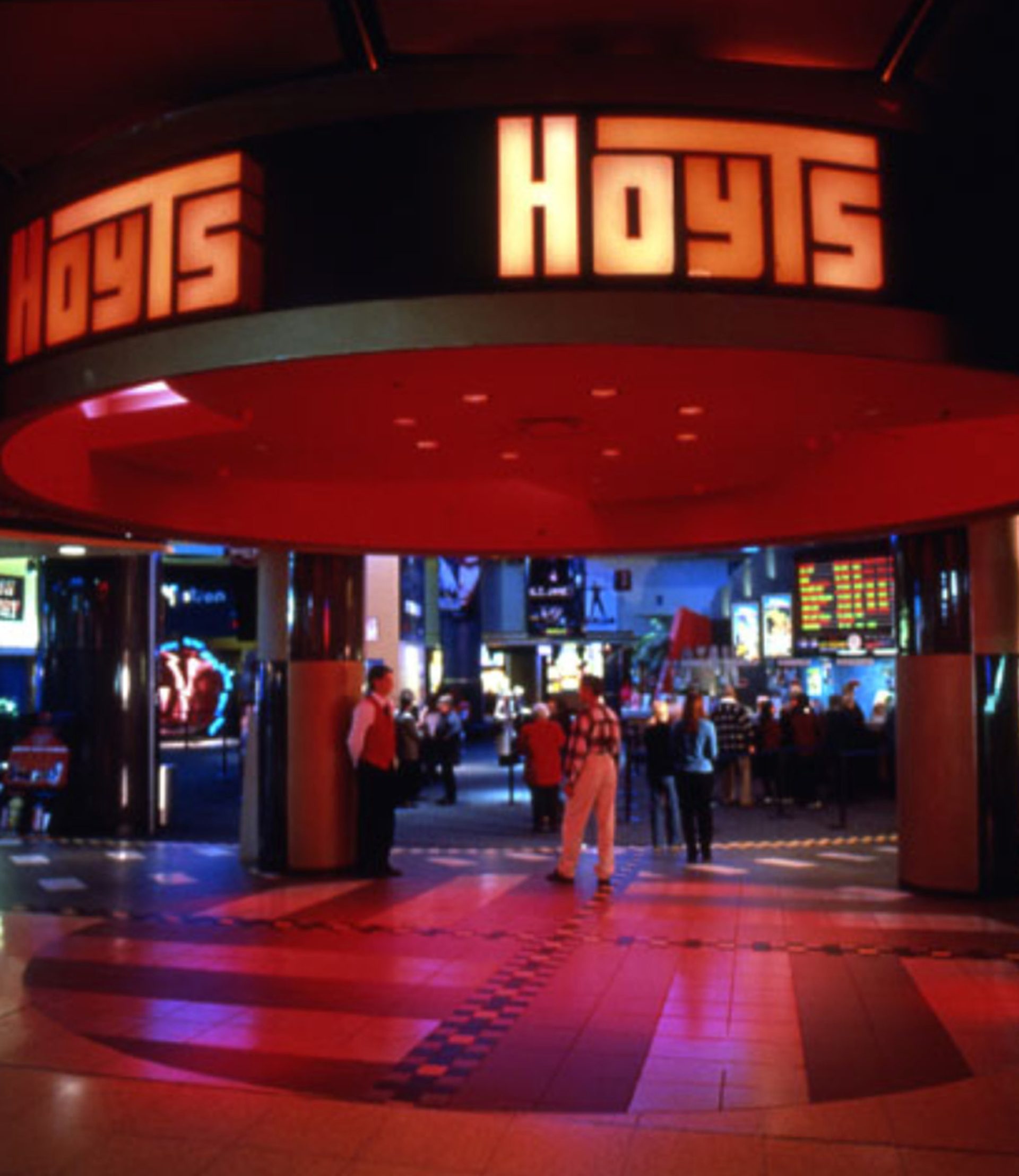 A photograph of the Hoyts entrance in Penrith Plaza, with red lights, guests and a cinema staff standing at the front.