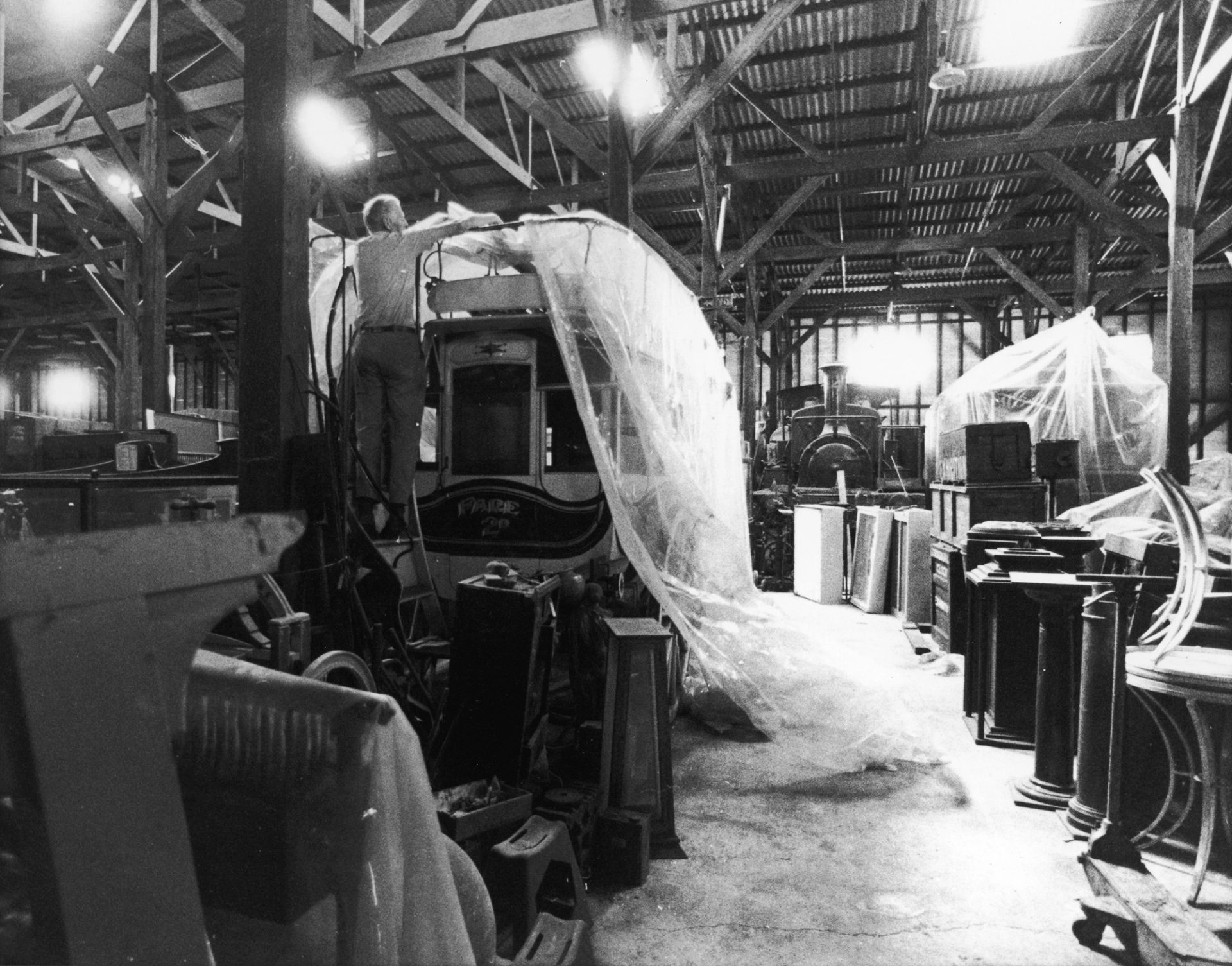 Black and white photograph of museum employee and a coach