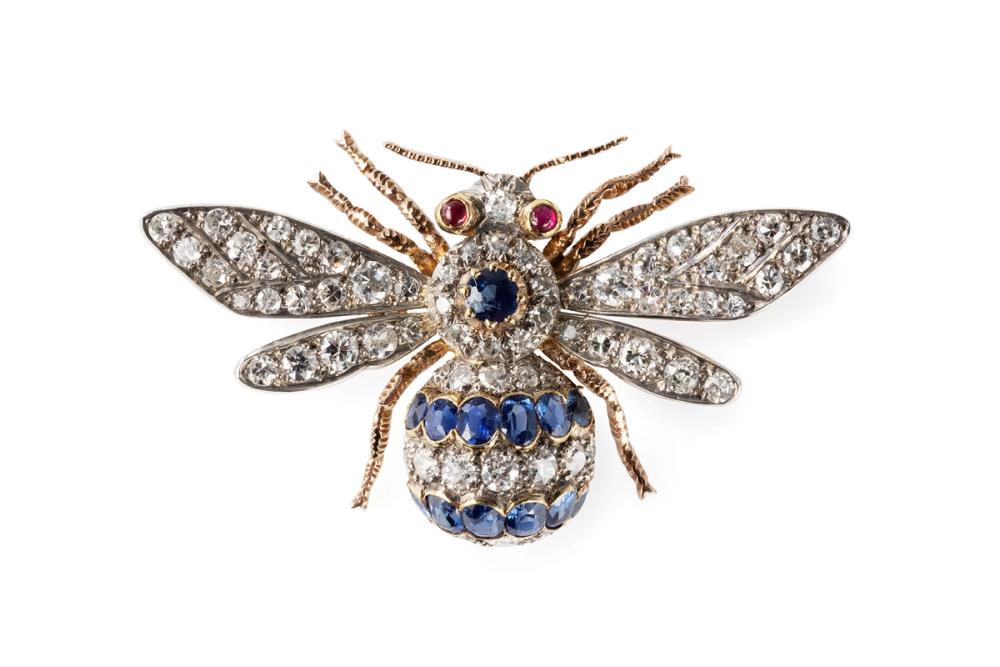 A brooch in the shape of a bee made out of gold, diamonds, sapphires and rubies.