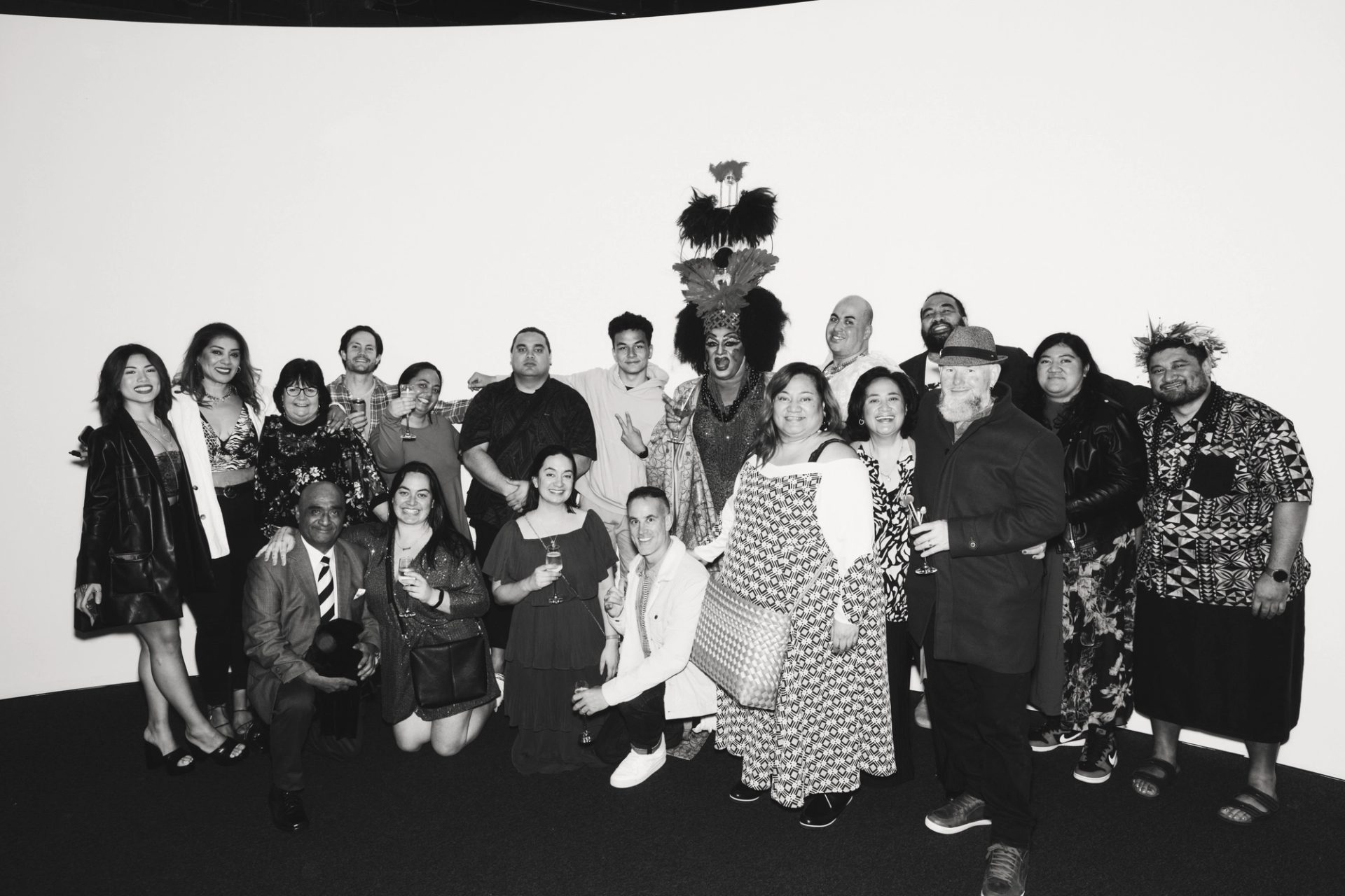 A large group of people posing in front of a white wall at the Powerhouse Museum, Ultimo.