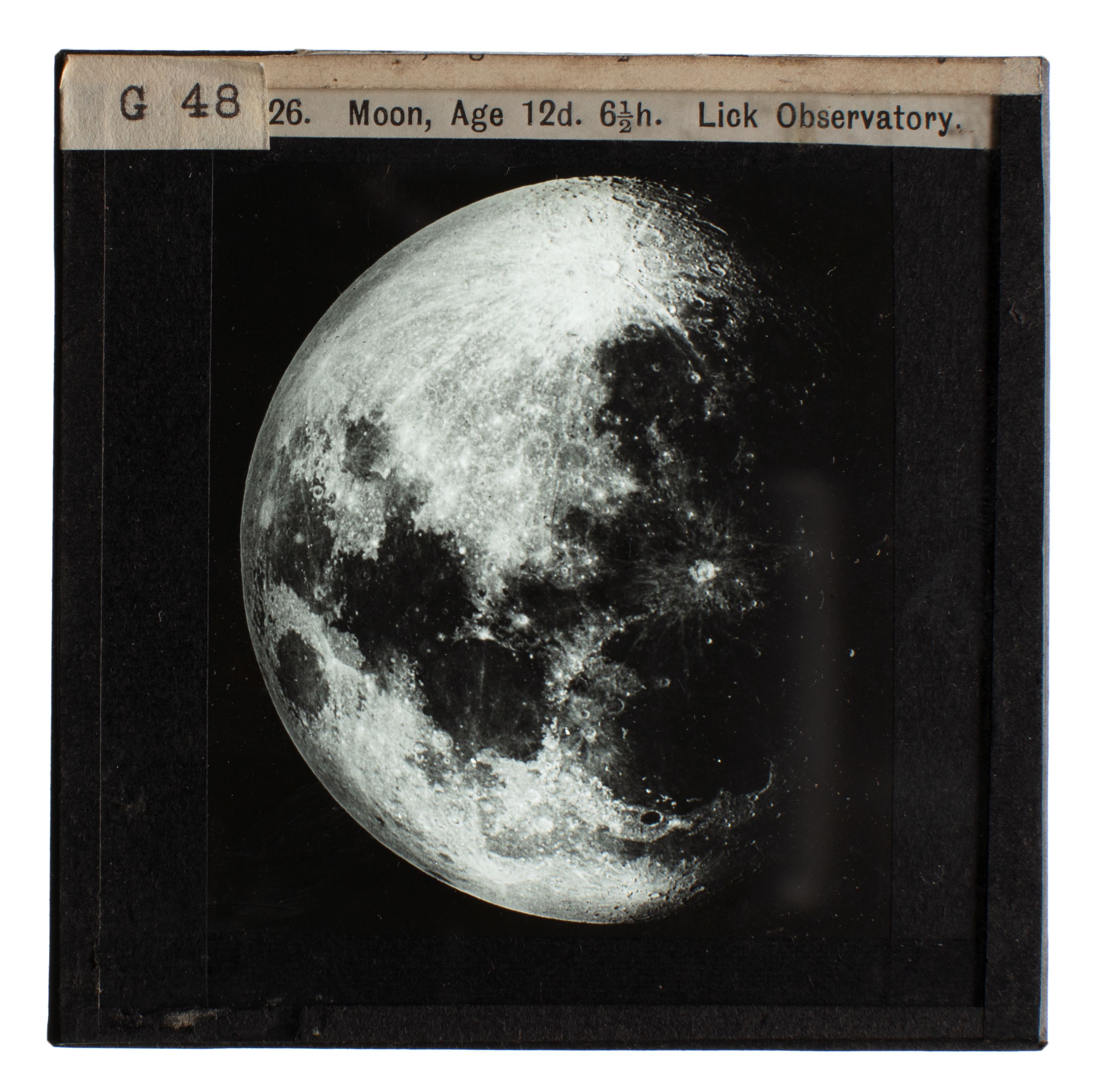 Photograph of a glass lantern slide used for teaching astronomy depicting the Moon at 12 1/2 days and 6 1/2 hours from the Lick Observatory.
