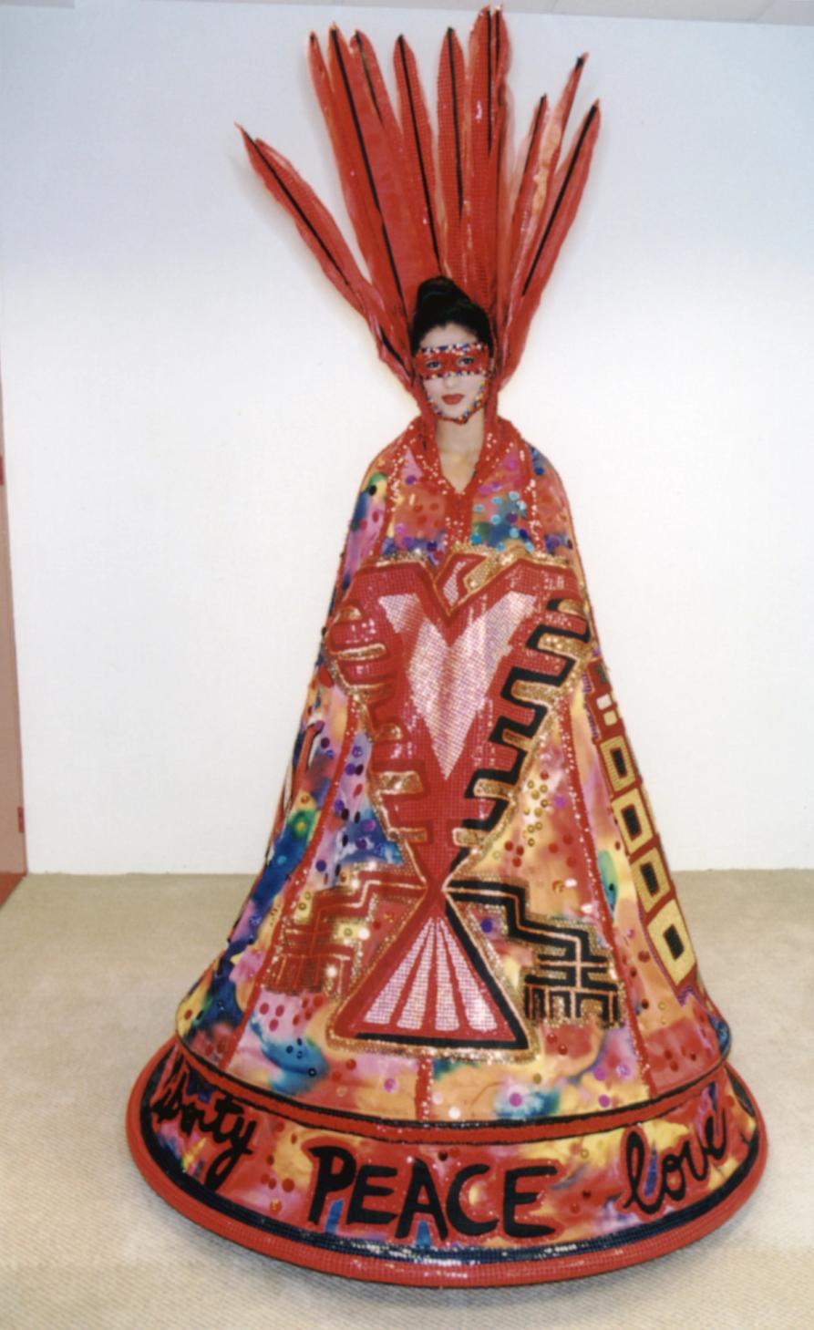 A woman dress in decorative red cloak-like dress with feather head piece and red eye mask.