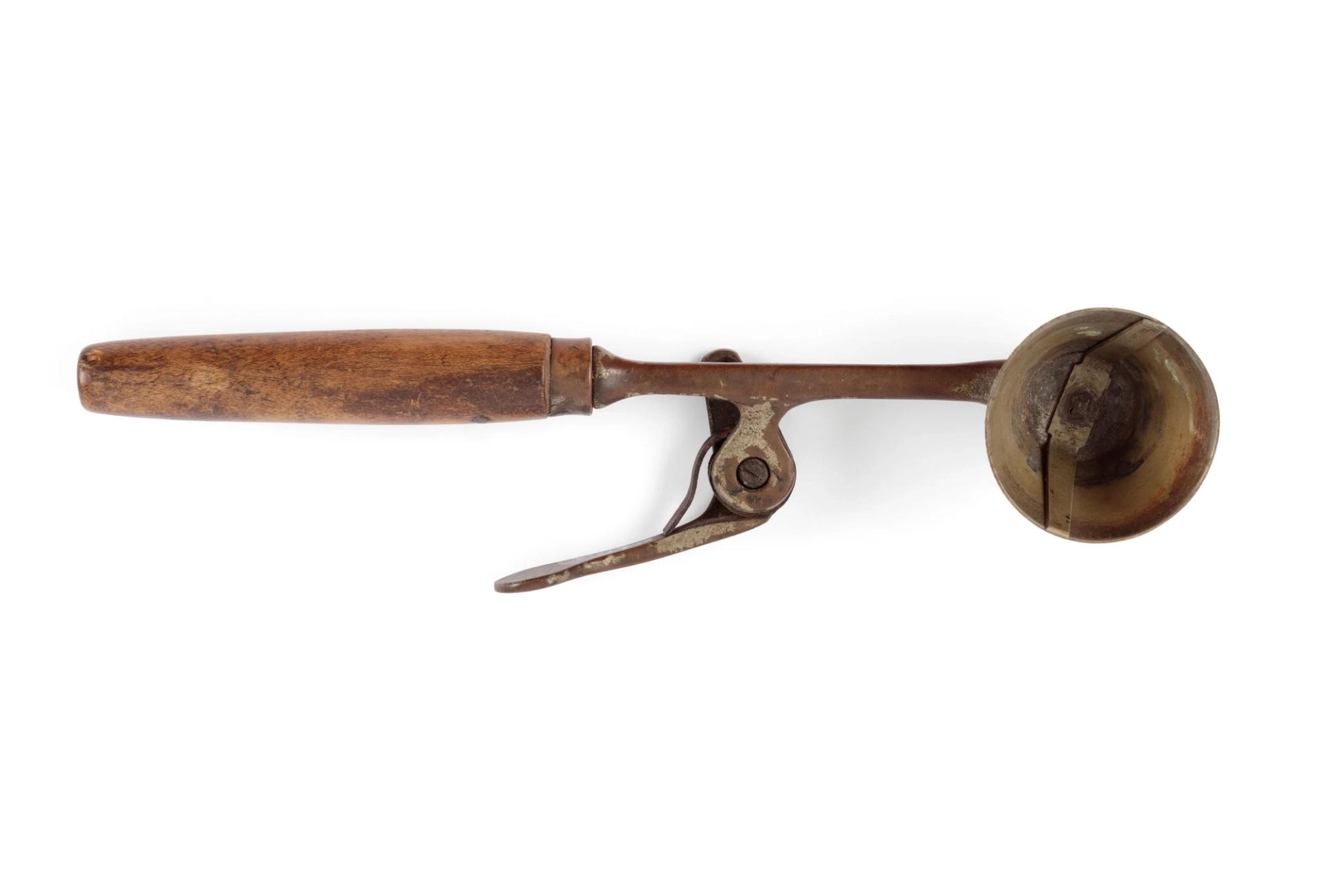 A metal ice cream scoop with wooden handle.