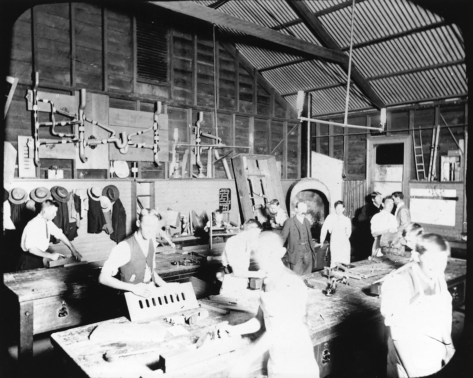Glass plate negative of students receiving a technical education in plumbing