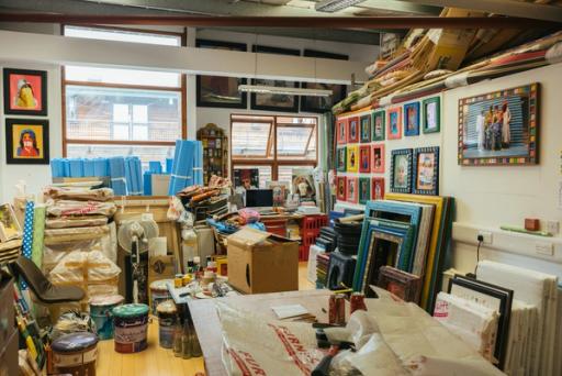 Frames, storage boxes and items inside a studio space.