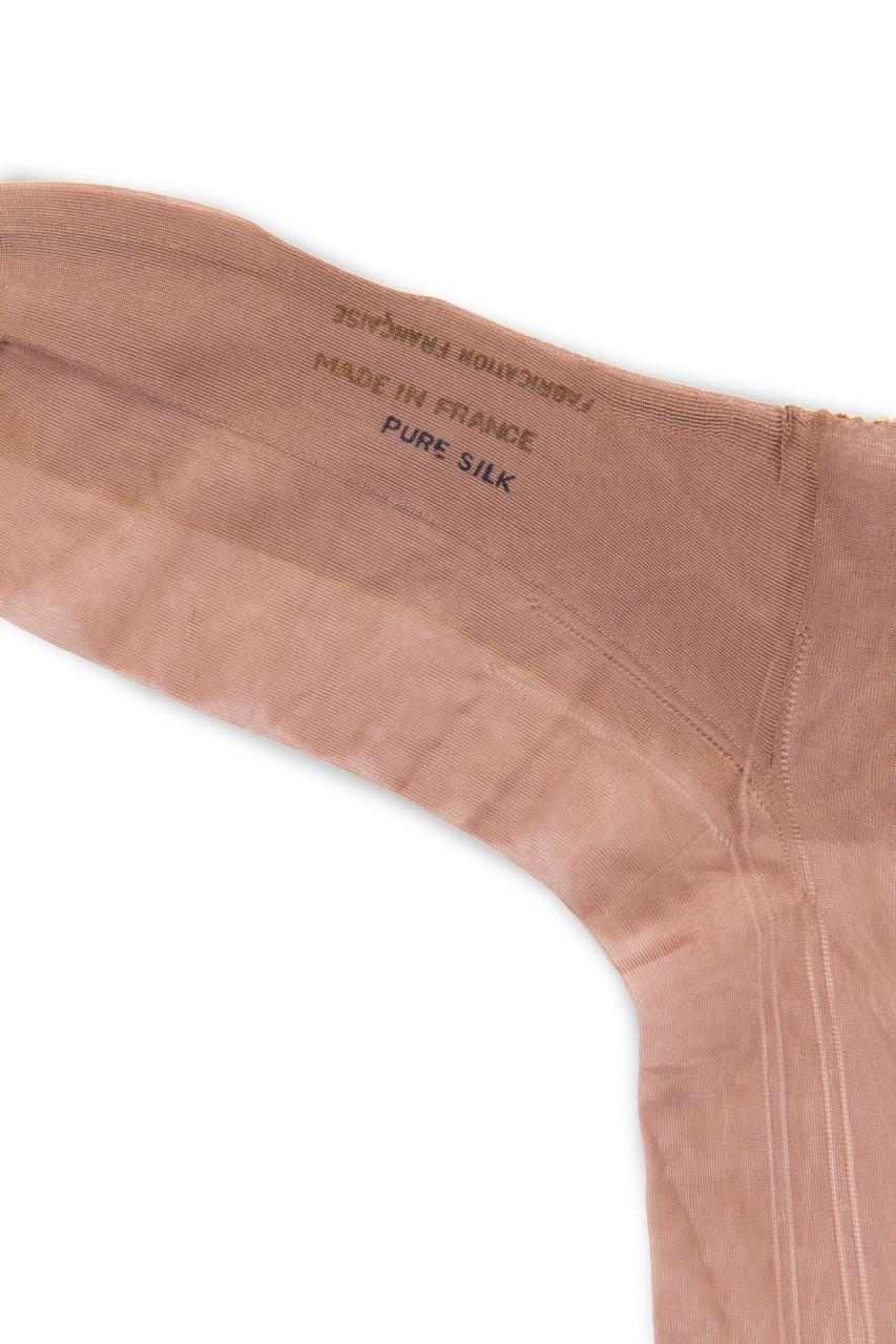 Pair of nude tone silk stockings.