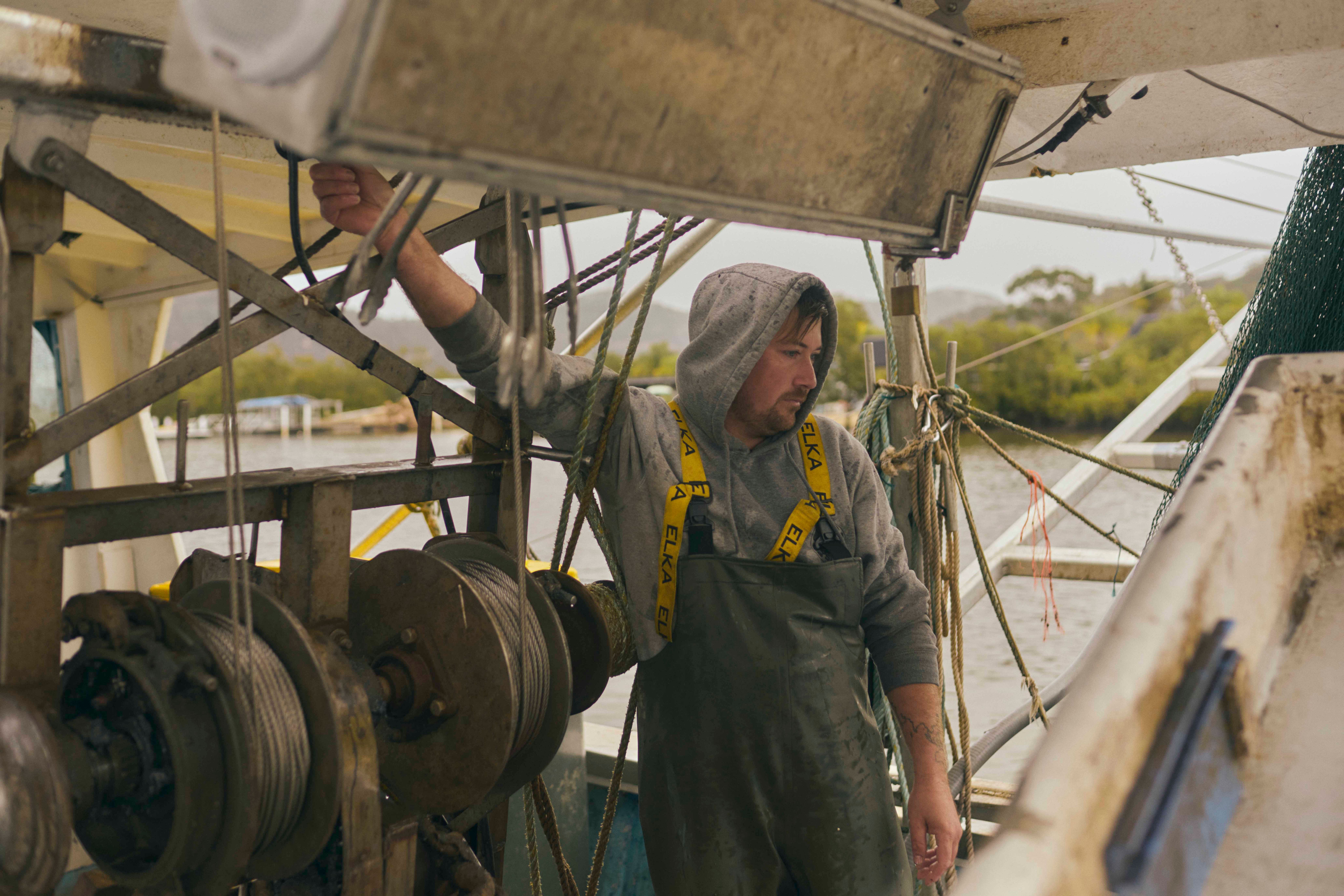 Figure working underneath machinery.