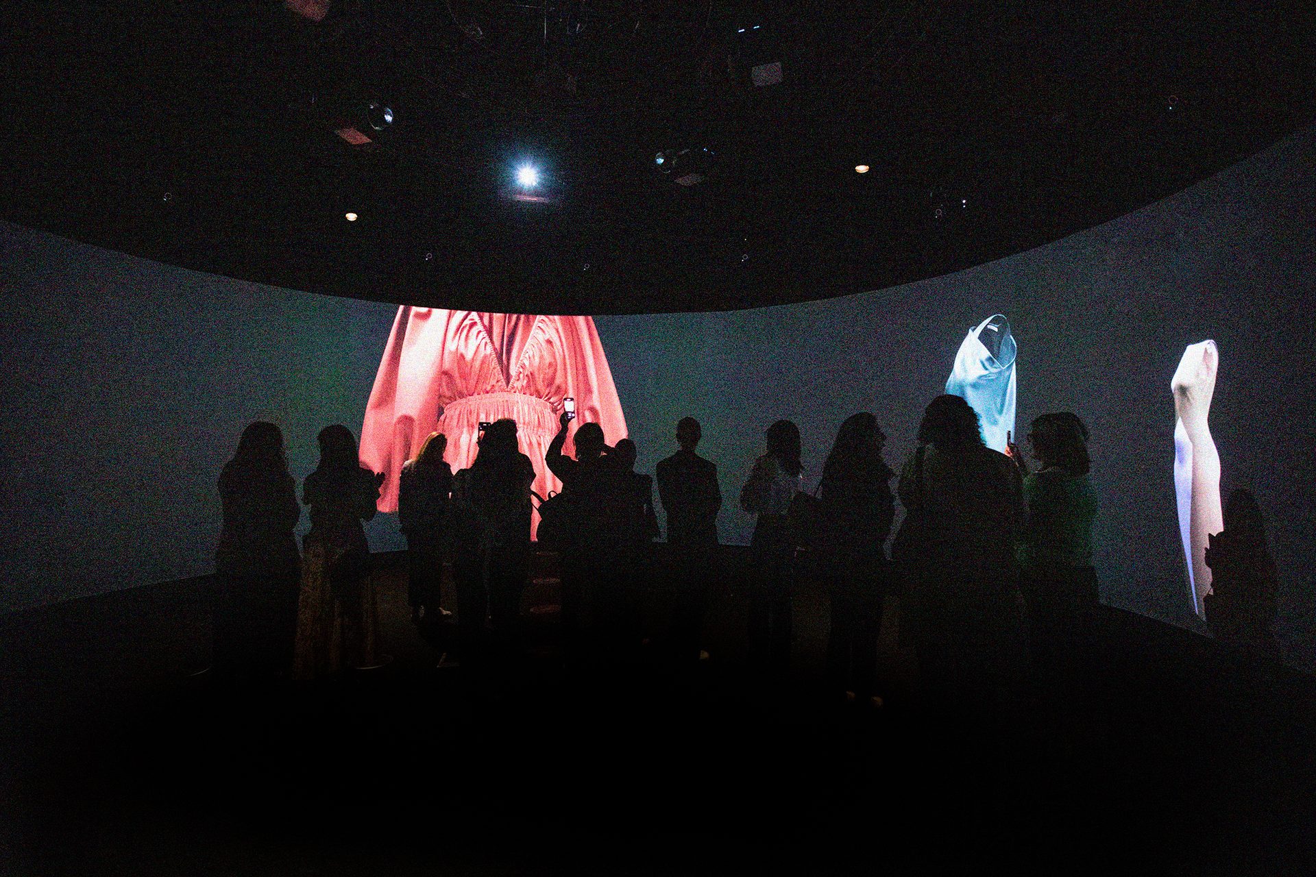 People stand within a digital exhibition