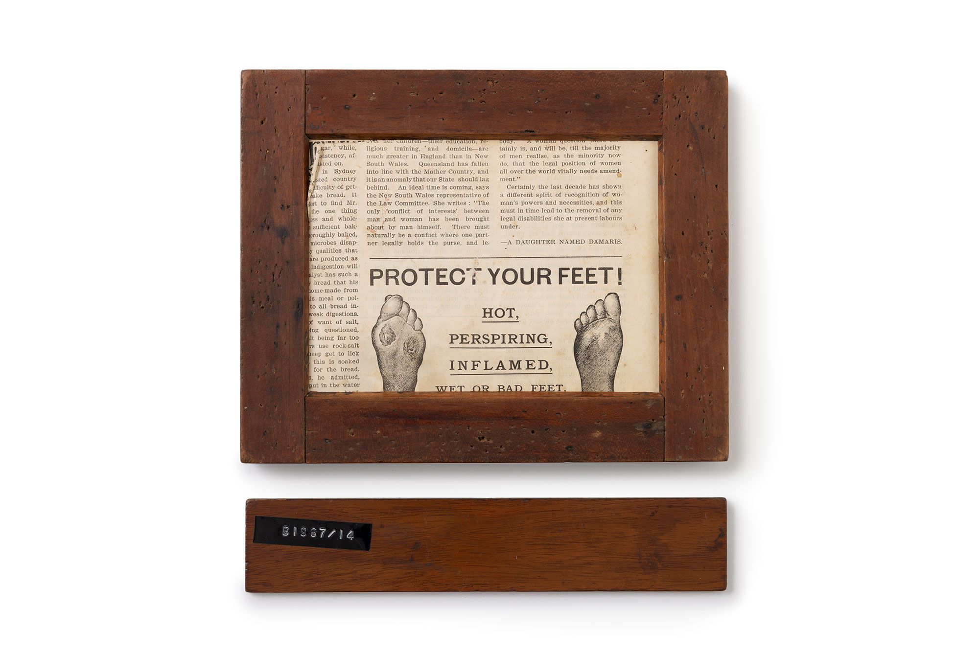 A wooden frame with a sheet of news print inside. Text in bold states ‘PROTECT YOUR FEET!’ with two illustrated feet underneath.