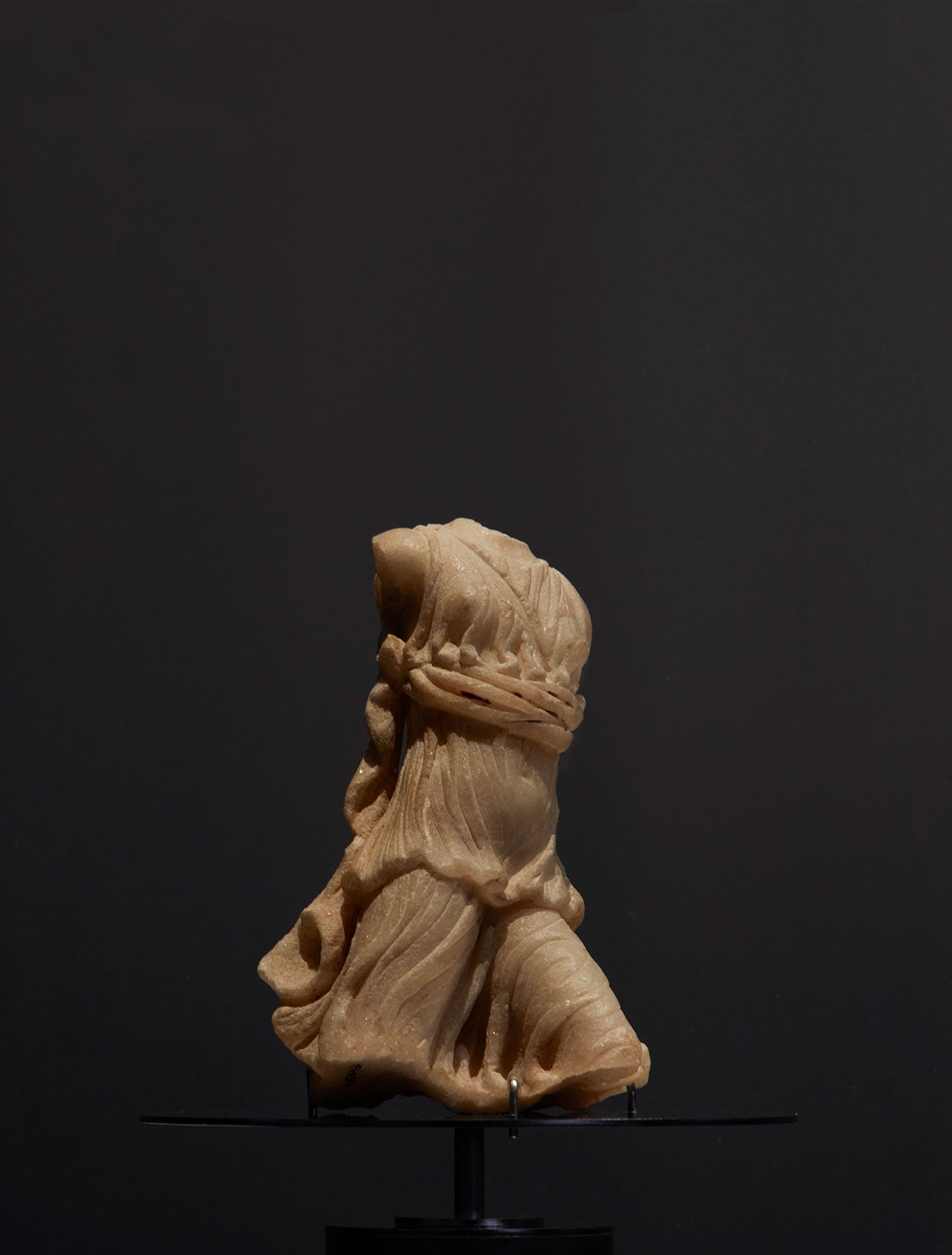 White marble statuette of Artemis (Diana) striding forward with left leg advanced.