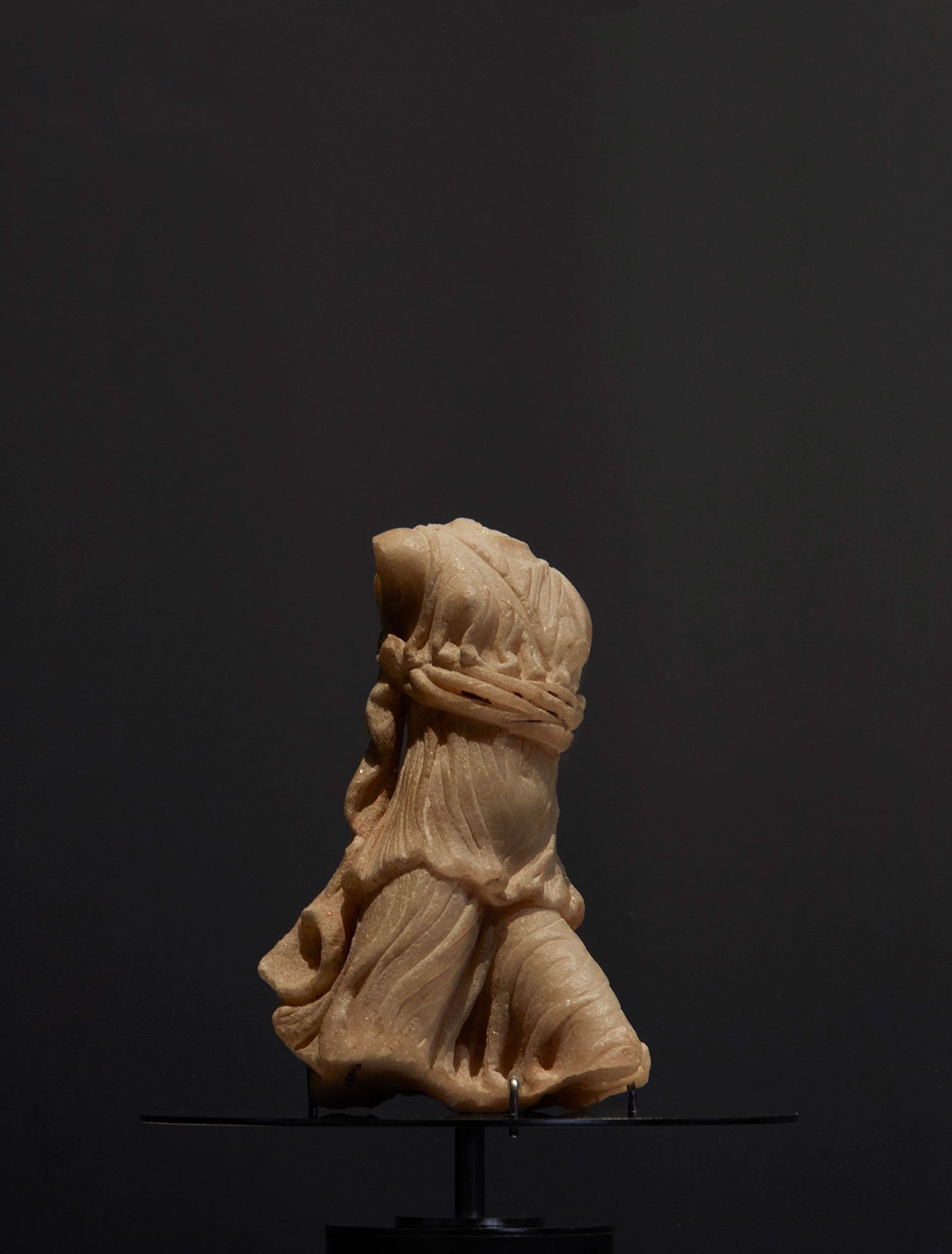 White marble statuette of Artemis (Diana) striding forward with left leg advanced.