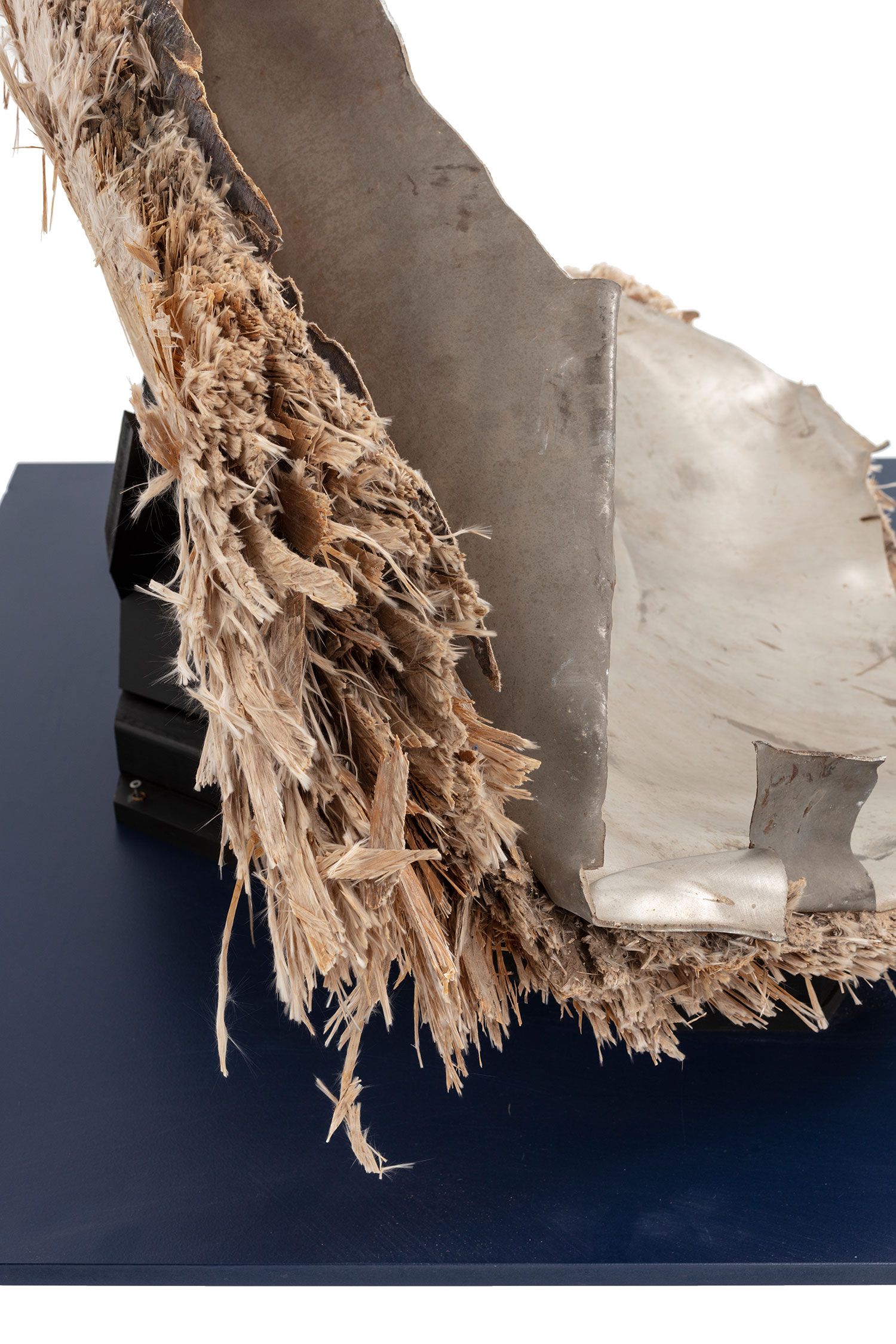 Space debris, Skylab space station, titanium/fibreglass, McDonnell Douglas Astronautics Co, USA, 1970-1972. The fragment is the end cap from pressurised oxygen tank from the Skylab space station. Originally the end of an enclosed cylinder, the titanium tank structure is torn and bent as a result of the stresses that ripped it away from the rest of the vessel. The exterior is covered by a composite insulation material with a woven fibreglass outer surface. A circular lid, protruding above the external insulation, covers an access hatch to the tank. A black and red wire, possibly originally connected to an external power source or sensor, is attached to the lid.