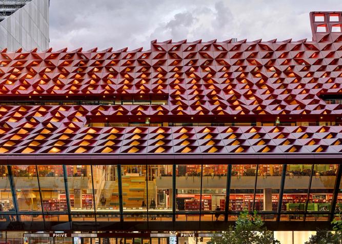 The red rooftop of Phive, featuring small undulations, that create a wavey pattern across the building.