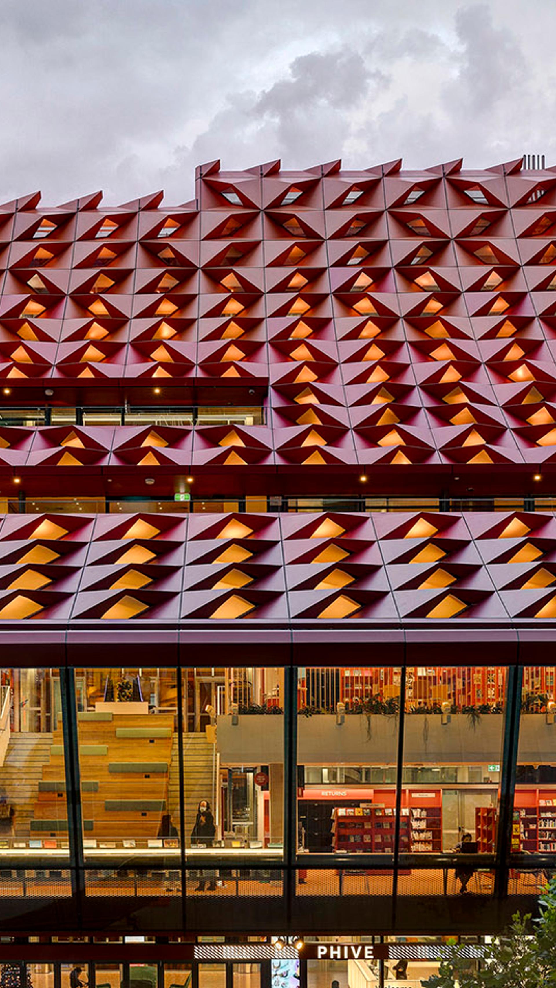The red rooftop of Phive, featuring small undulations, that create a wavey pattern across the building.