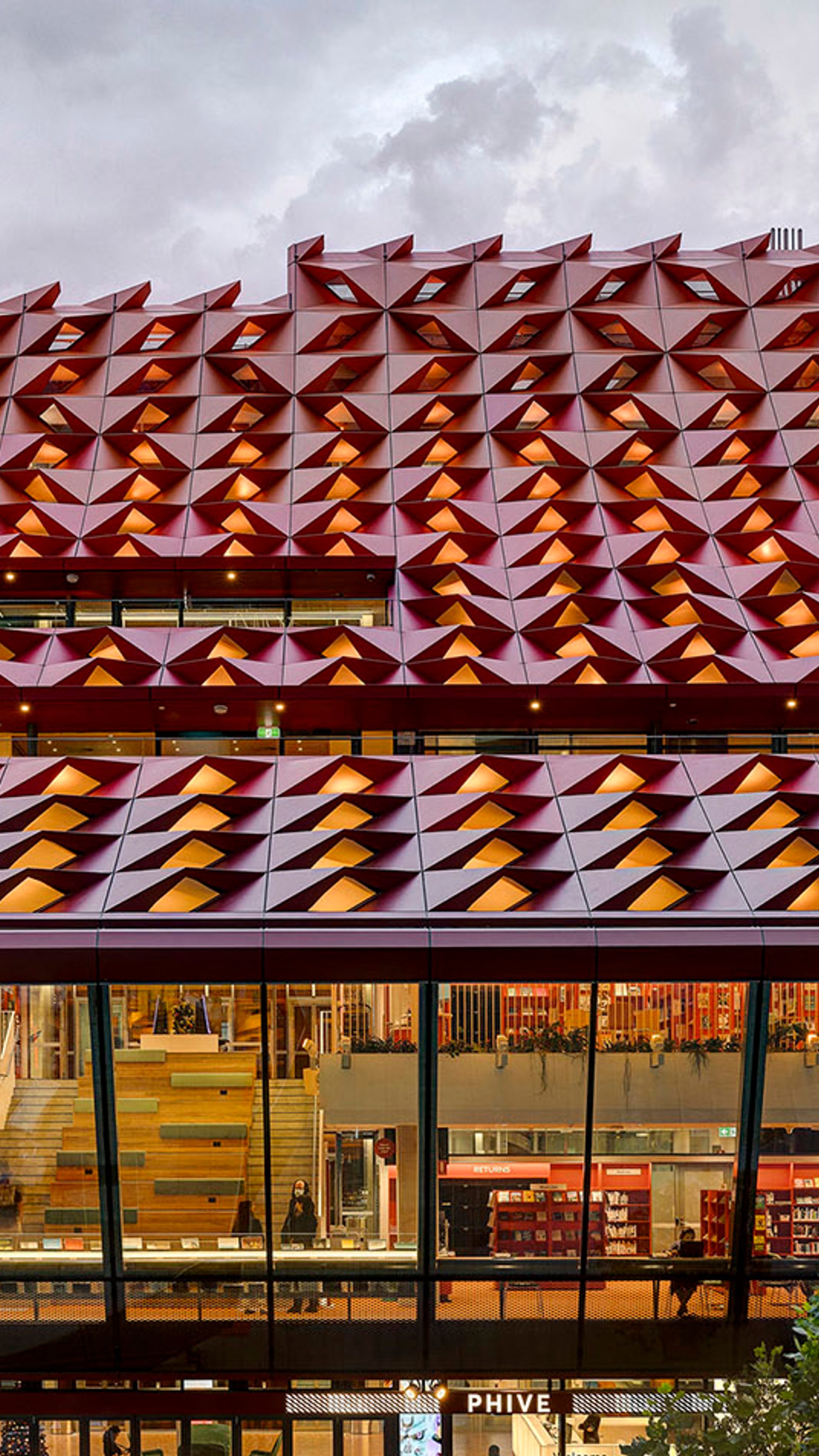 The red rooftop of Phive, featuring small undulations, that create a wavey pattern across the building.