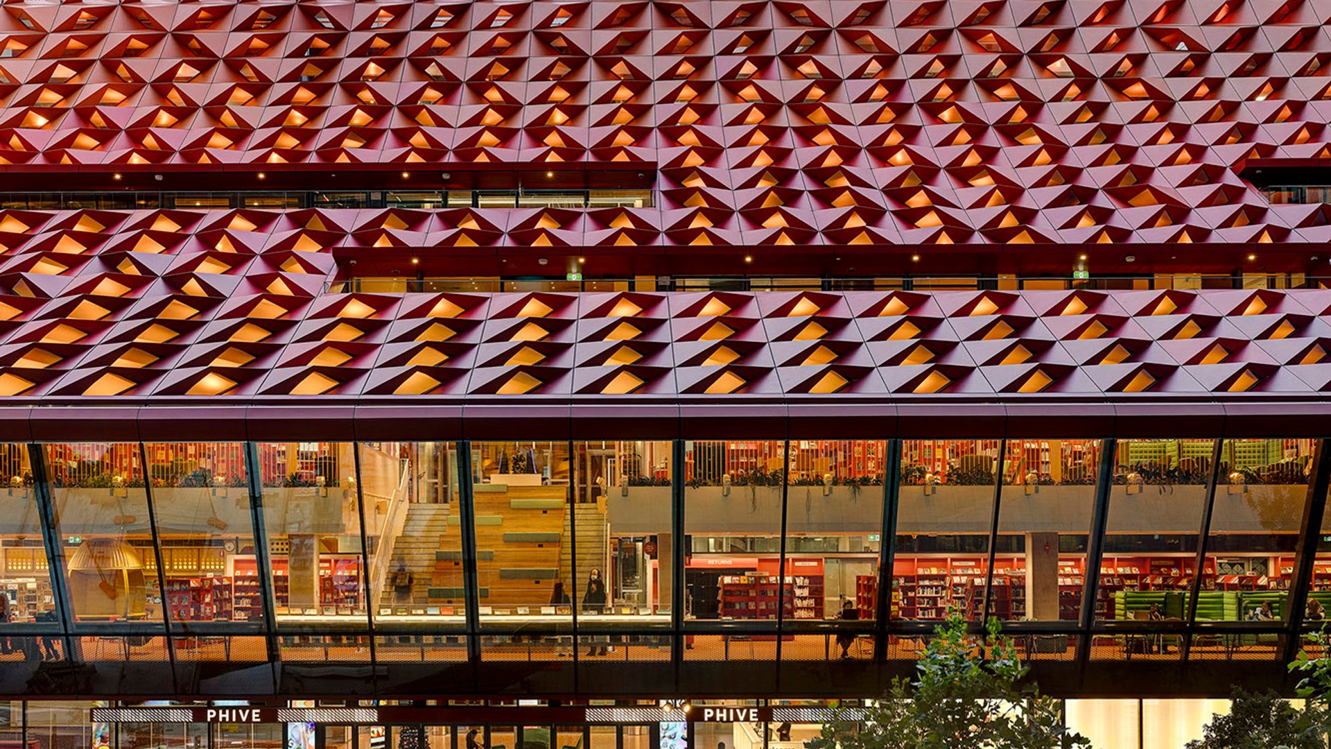 The red rooftop of Phive, featuring small undulations, that create a wavey pattern across the building.