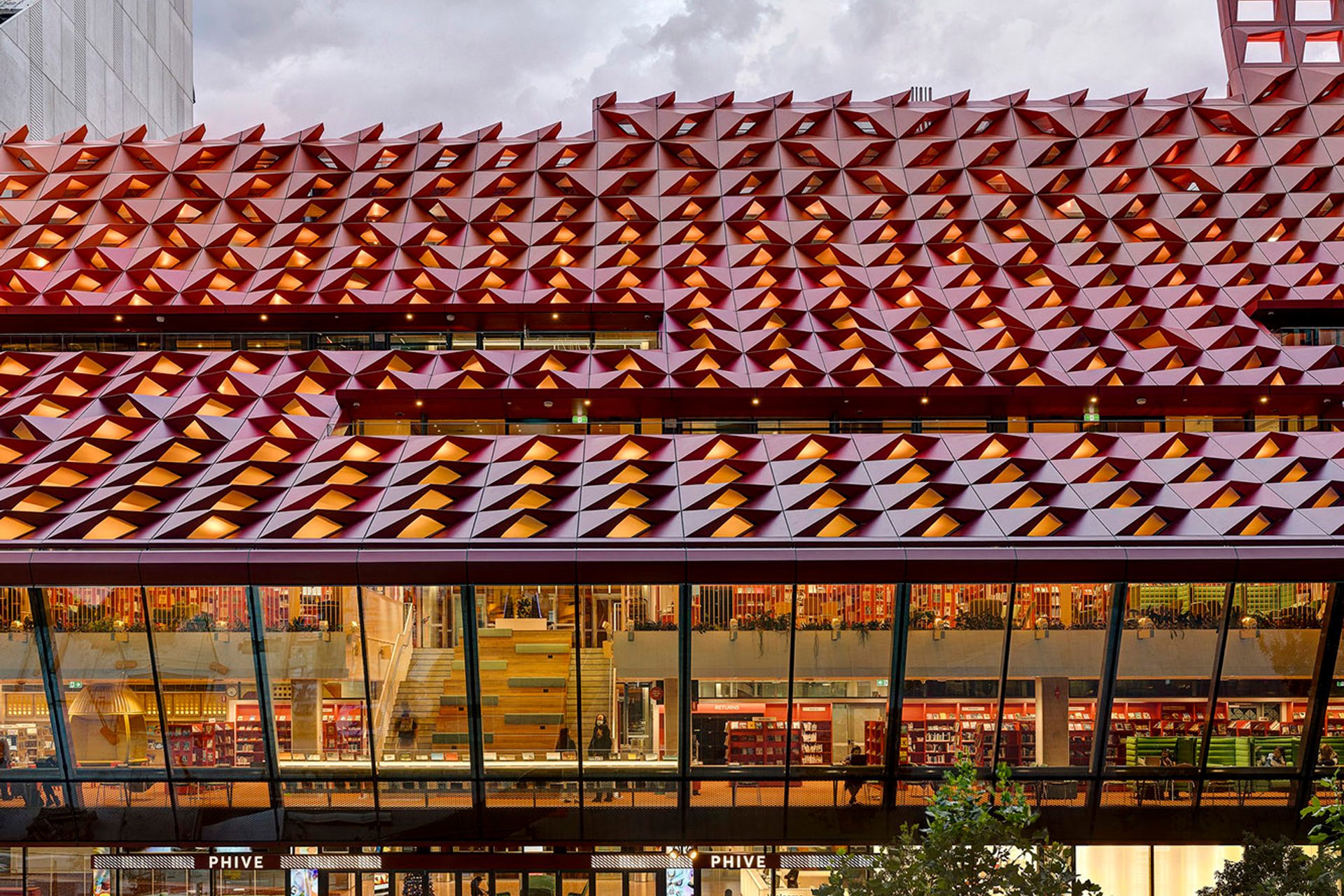 The red rooftop of Phive, featuring small undulations, that create a wavey pattern across the building.