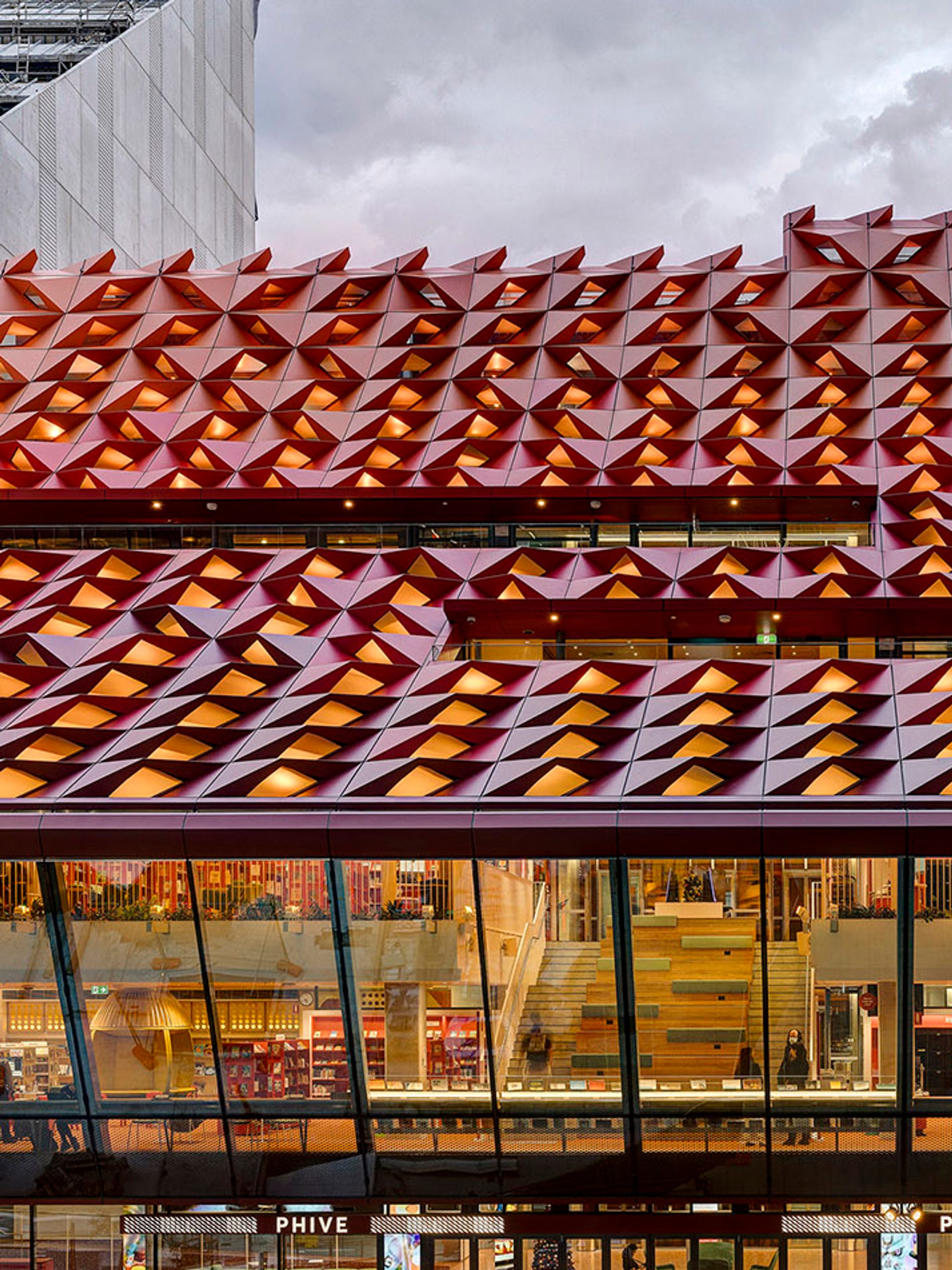 The red rooftop of Phive, featuring small undulations, that create a wavey pattern across the building.