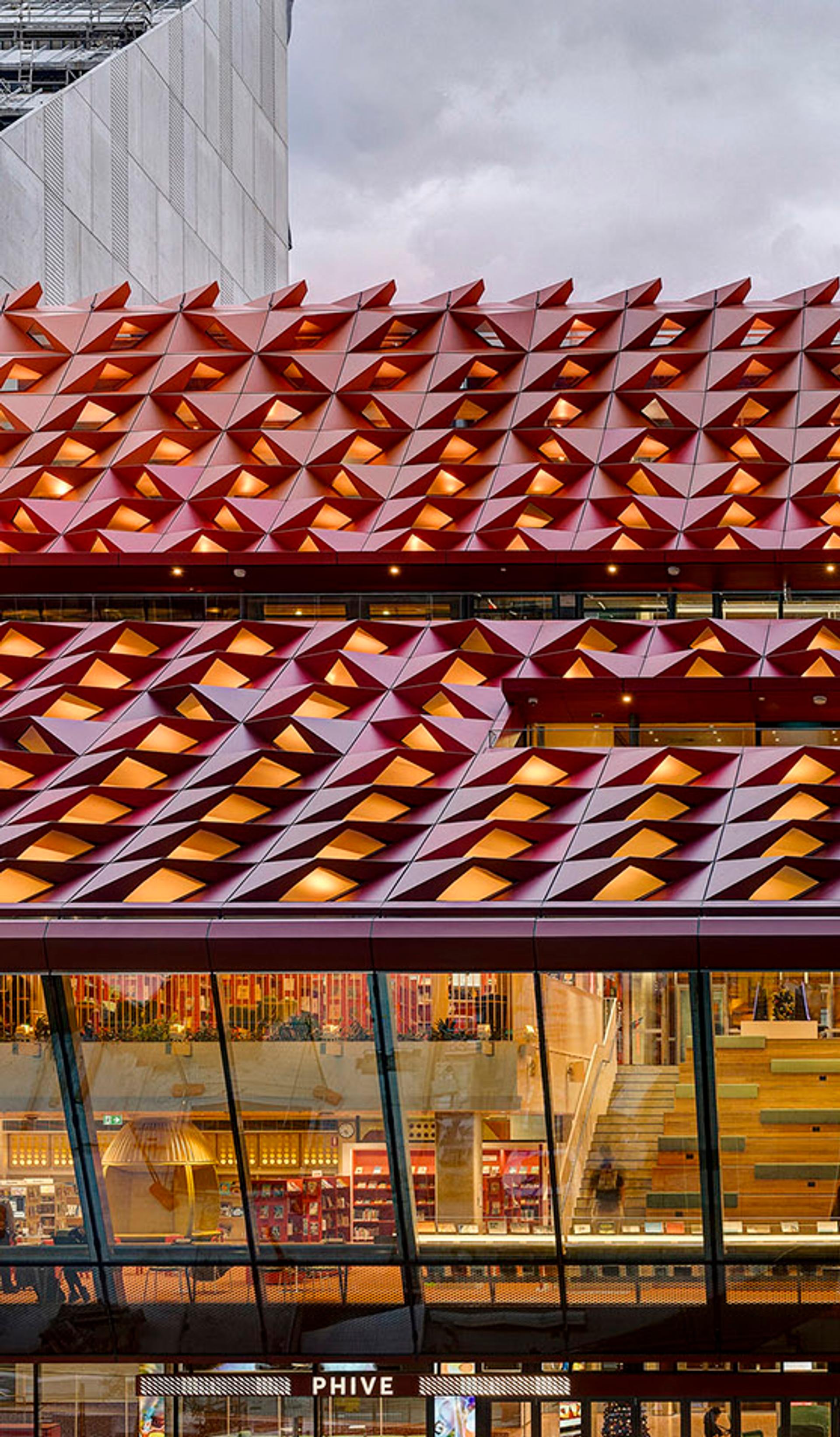 The red rooftop of Phive, featuring small undulations, that create a wavey pattern across the building.