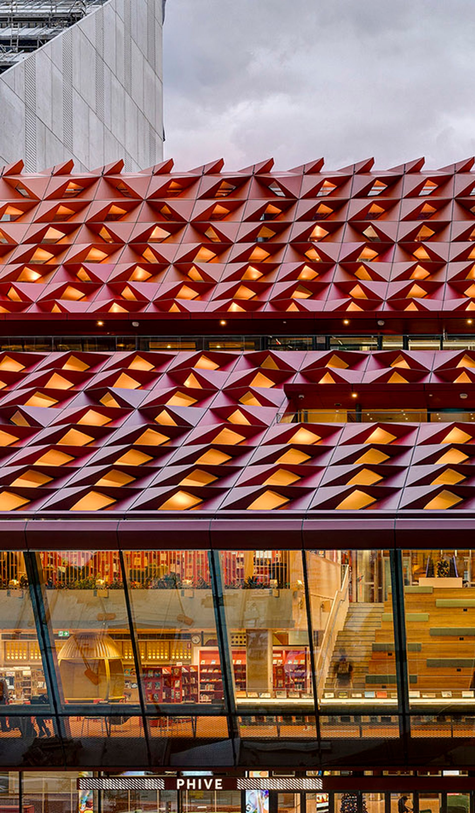 The red rooftop of Phive, featuring small undulations, that create a wavey pattern across the building.