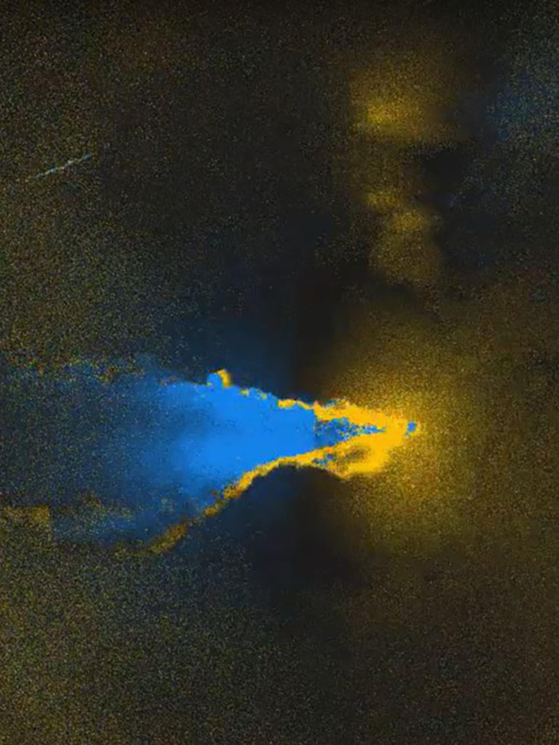 Yellow rings faded into darkness, with a blue cloud flowing left out of frame.
