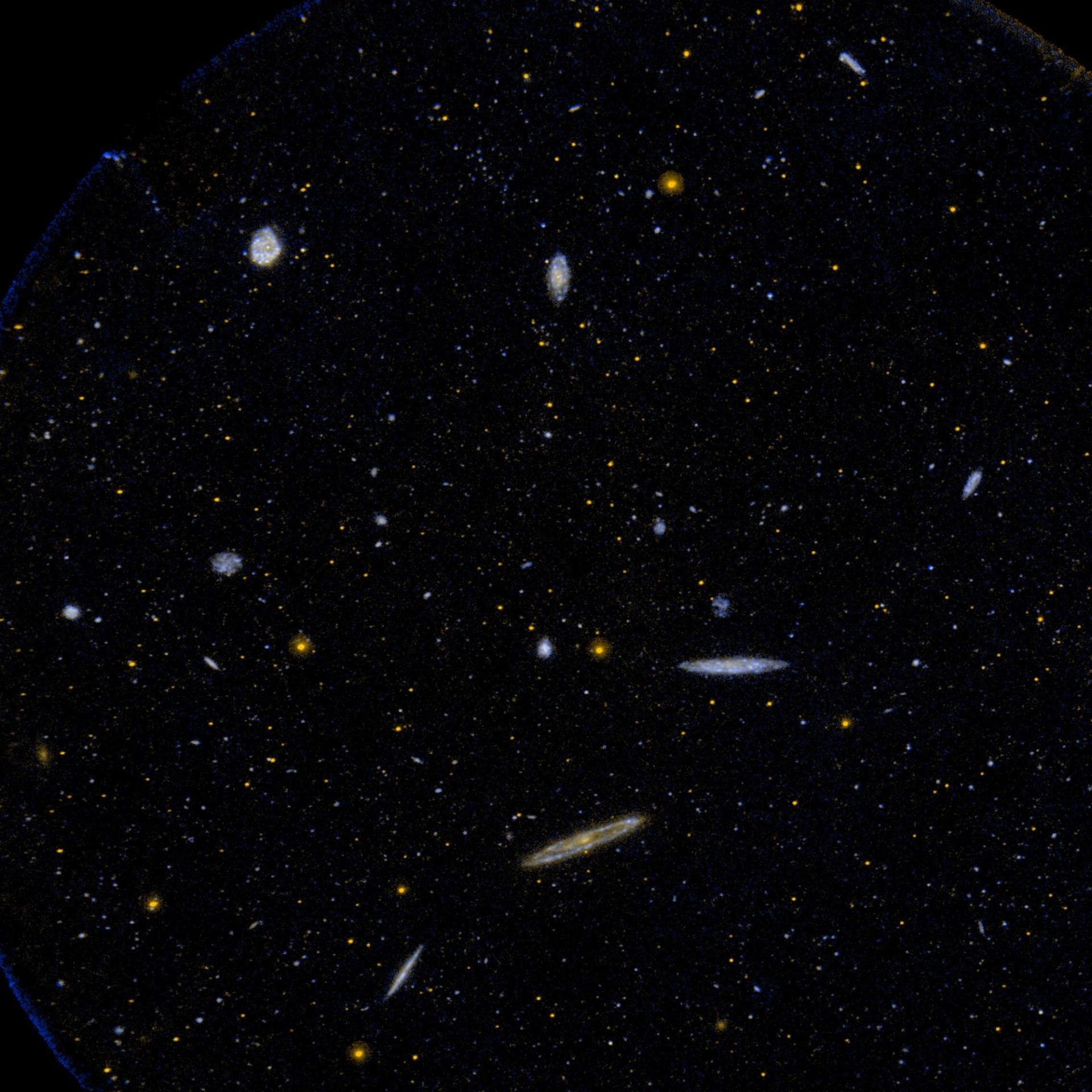 An ultraviolet image of space from NASA Galaxy Evolution Explorer showing a small area of the Virgo Cluster of galaxies.