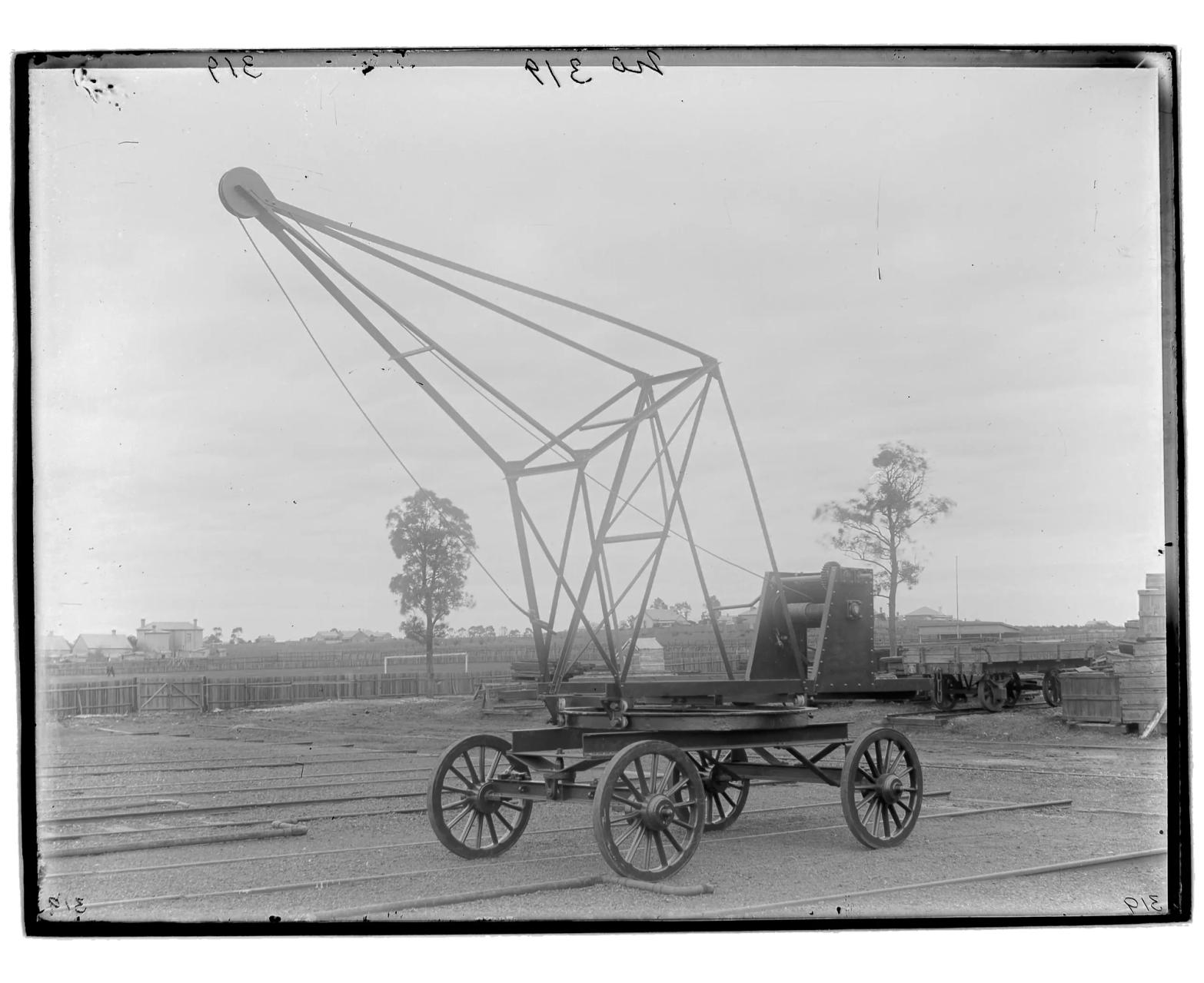 A rectangular black and white silver gelatin glass plate negative in landscape format. The image depicts a travelling agricultural crane for handling sugar cane, hay etc.
