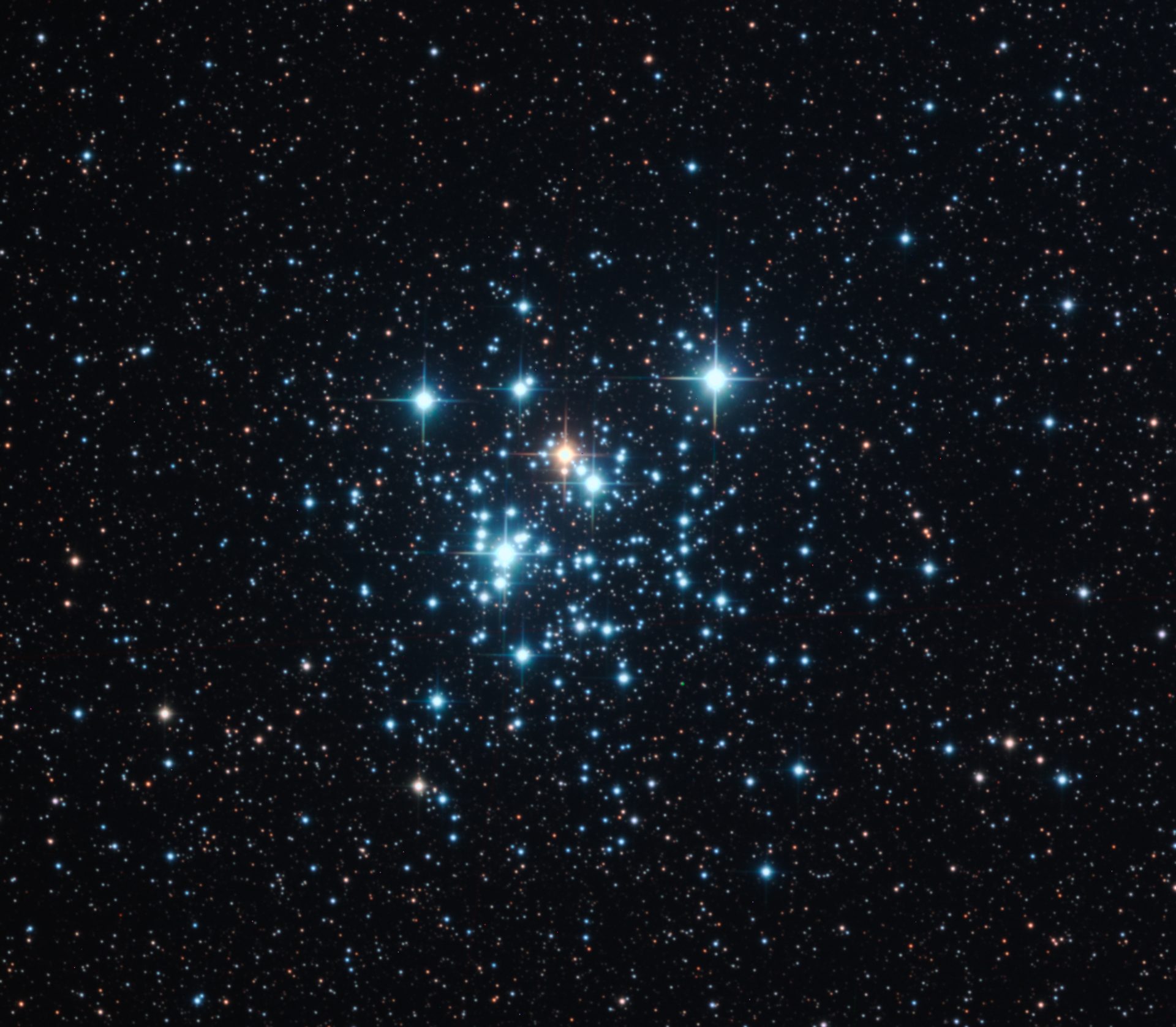 A telescopic image of a cluster of stars, known as The Jewel Box (NGC 4755). Against a dark space sky is the open cluster of stars, six shine brightest with one in the centre a golden colour, the rest a bright blue.
