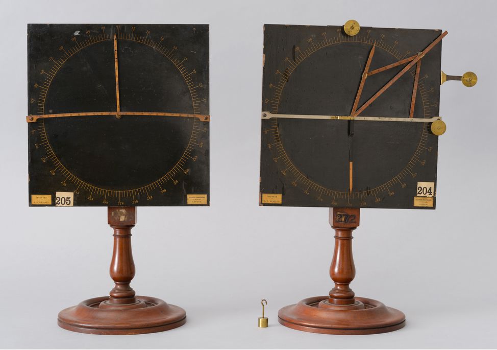 Two physics demonstration models comprising charts and stands, designed to illustrate some of the basic principles of force, motion and gravity.