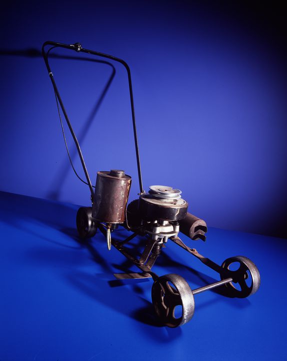 mower consisting of a lightweight rectangular metal frame with a metal wheel at each corner