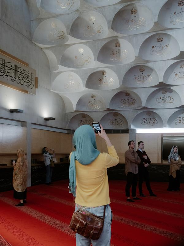Figure taking a photo of the Mosque's ceiling