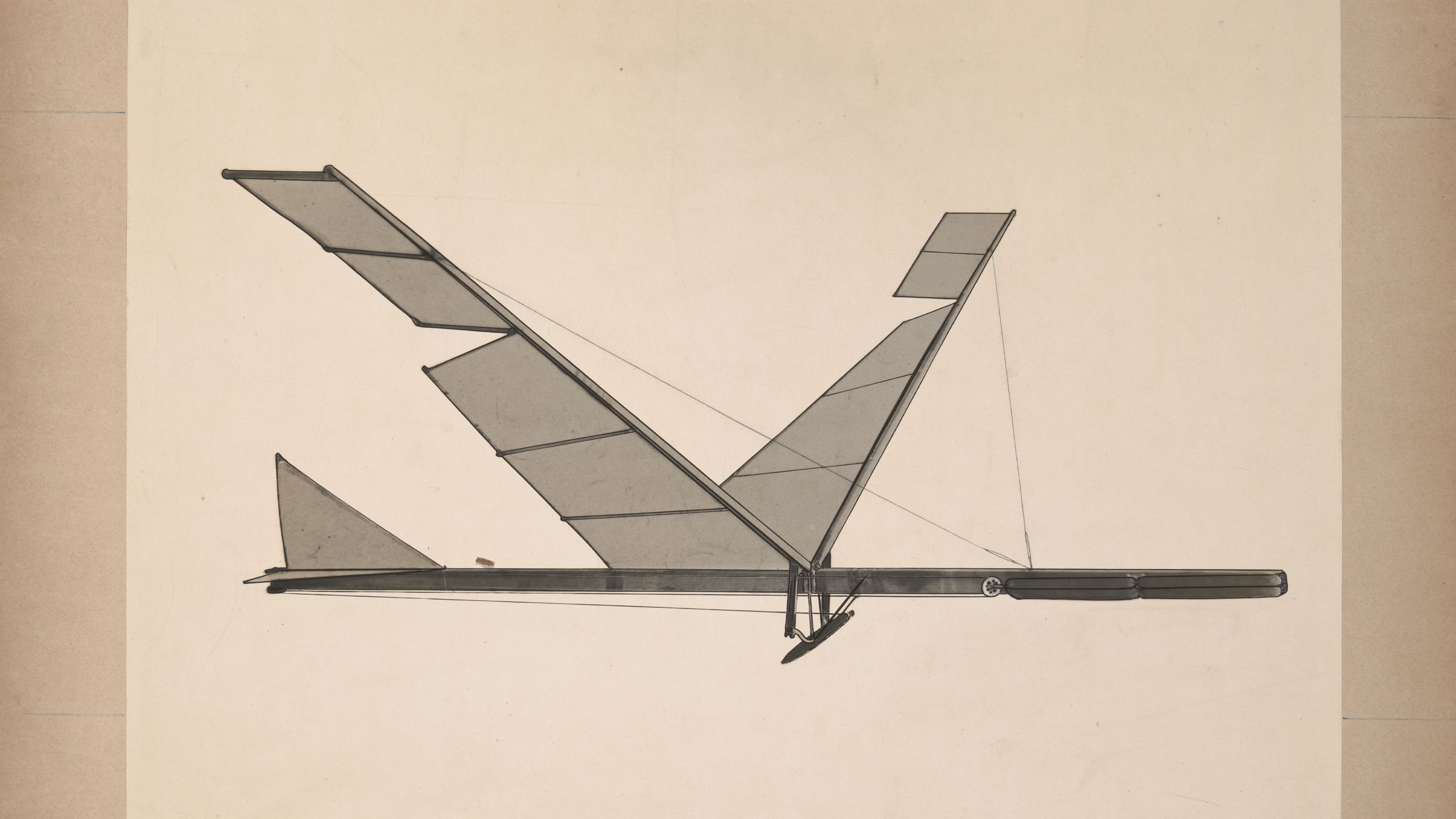 A black & white photograph depicting a rubber band flapping wing flying machine.