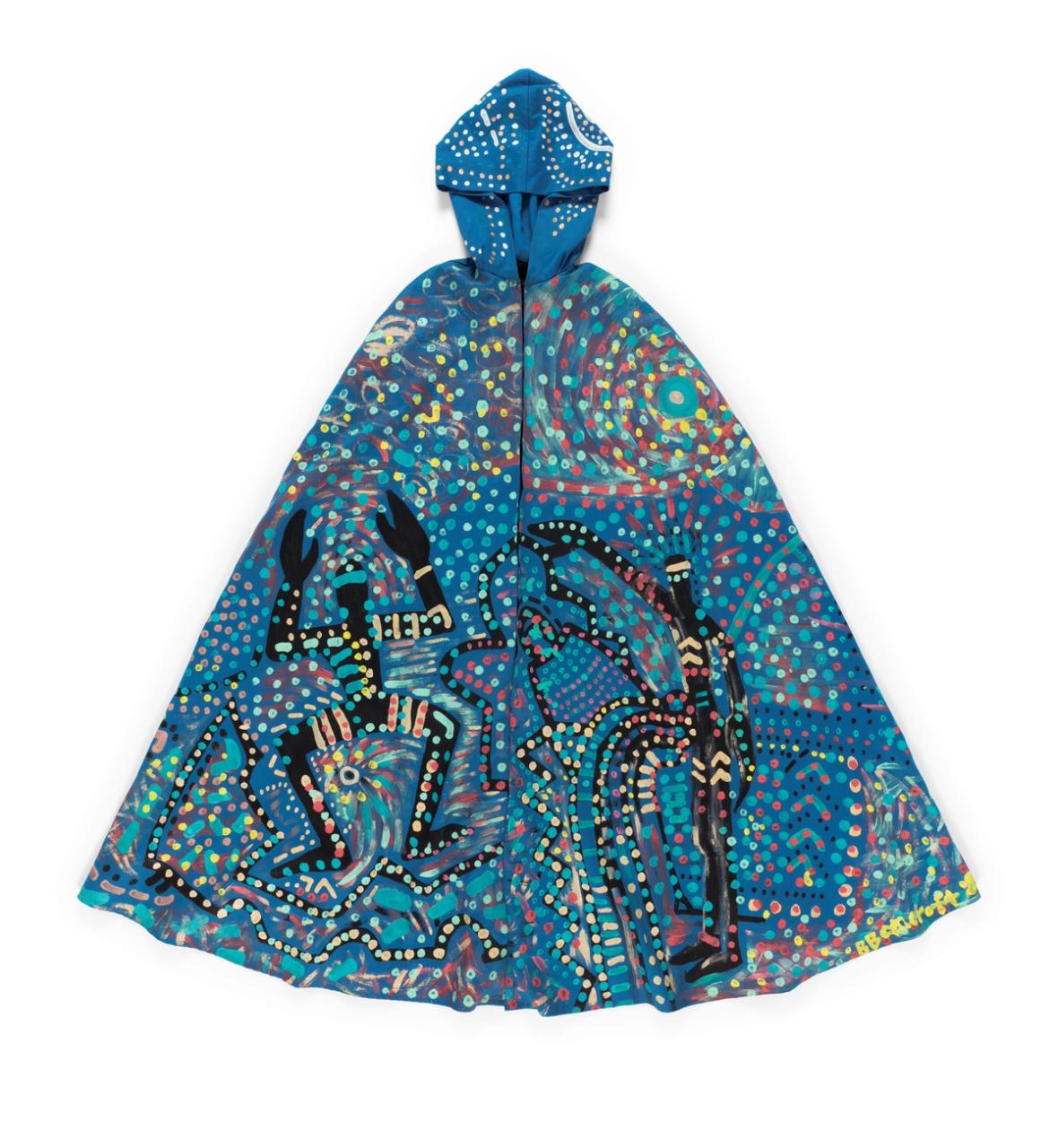 Full length opera cape with hood made of blue cotton drill lined with black polyester. Cape fastens at neck with centre front hook and eye fastening. Handpainted design using poster and fabric paint featuring two human figures on the front and a lizard on the back, representing the journey through life of an Aboriginal man and woman.