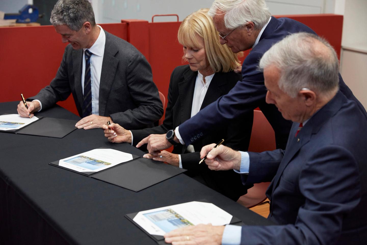 People signing documents