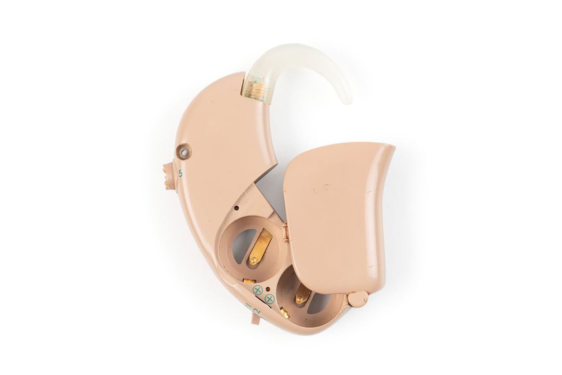 Tan coloured over the ear speech processor for a cochlear implant photographed against white background